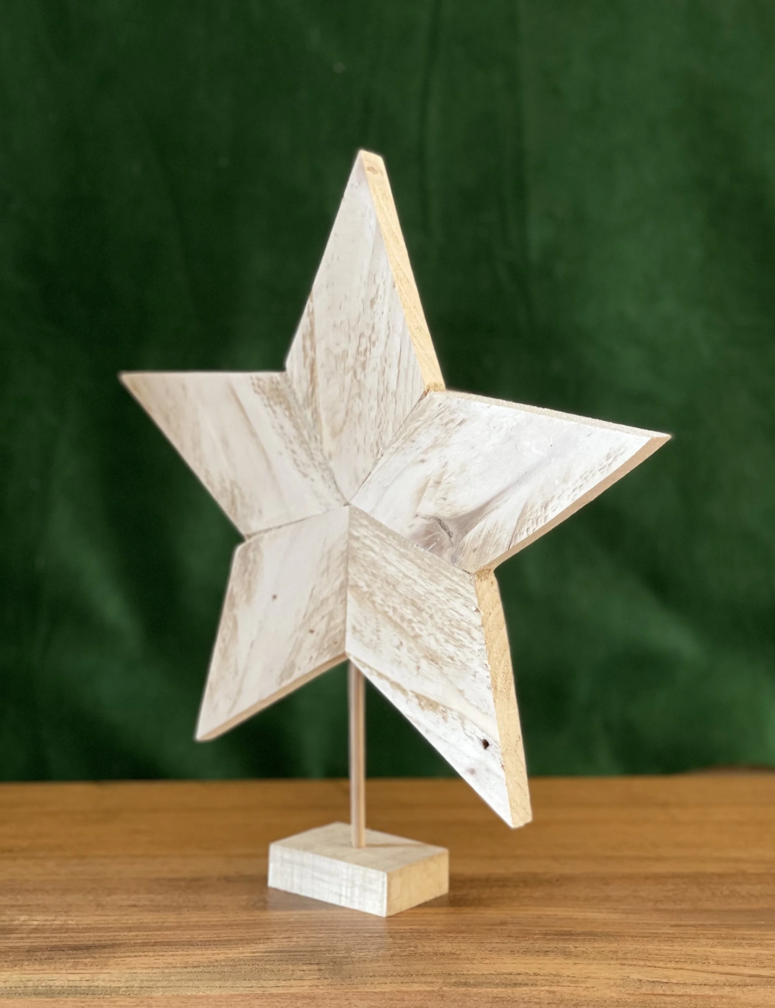 Wooden star with green background