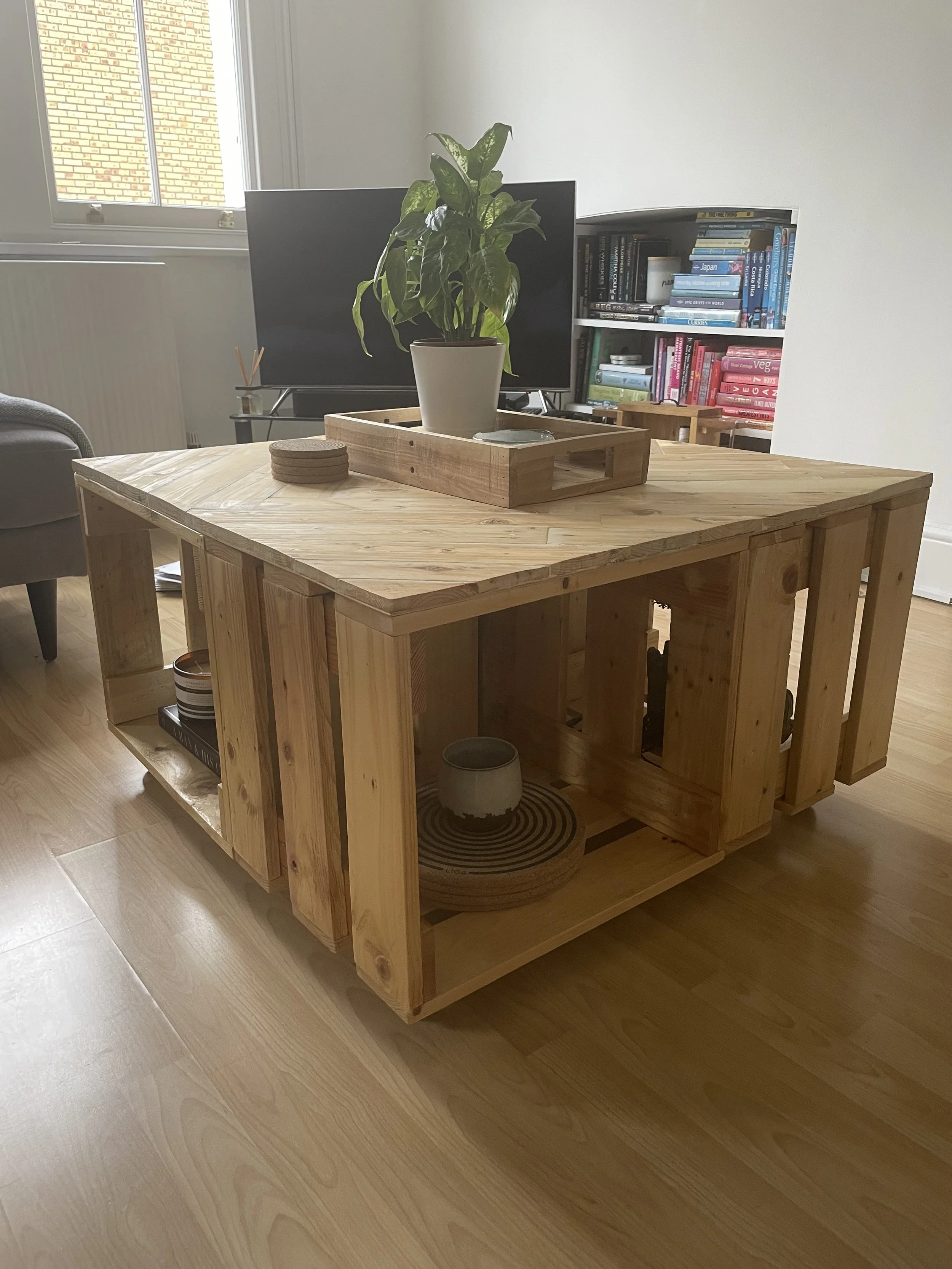 Wooden table with plant and wooden tray on to