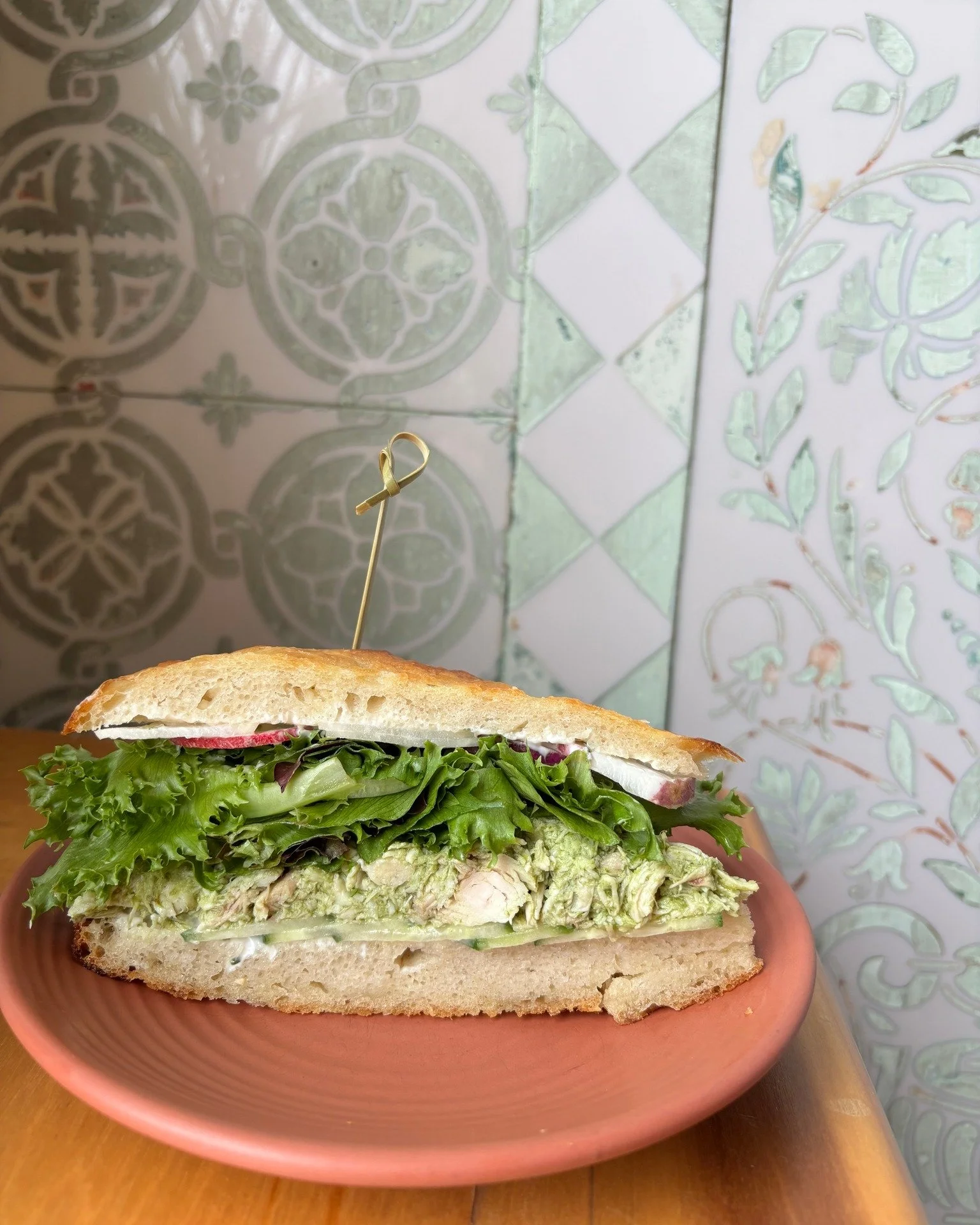 🥪 MEET THE GREEN GODDESS CHICKEN SALAD SANDO 🍃

Our newest Daily Saint Sandwich special is here, and she's beautiful. House made green goddess dressing packed with herbs and greens, confit chicken, cucumbers, lettuce, and radishes on our house made