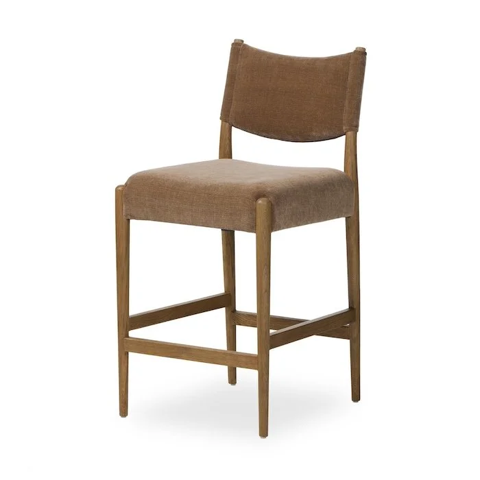 A wooden chair with a padded seat and backrest, upholstered in light brown fabric.