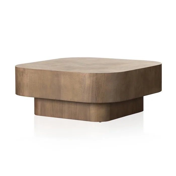 A wooden, irregularly shaped coffee table with a smooth, natural finish.