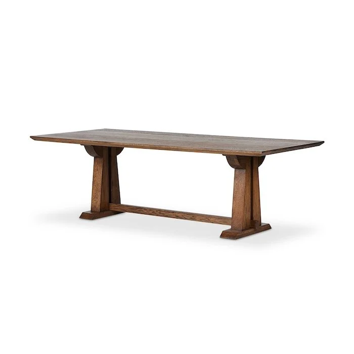 A wooden table with sturdy legs and a long rectangular top.