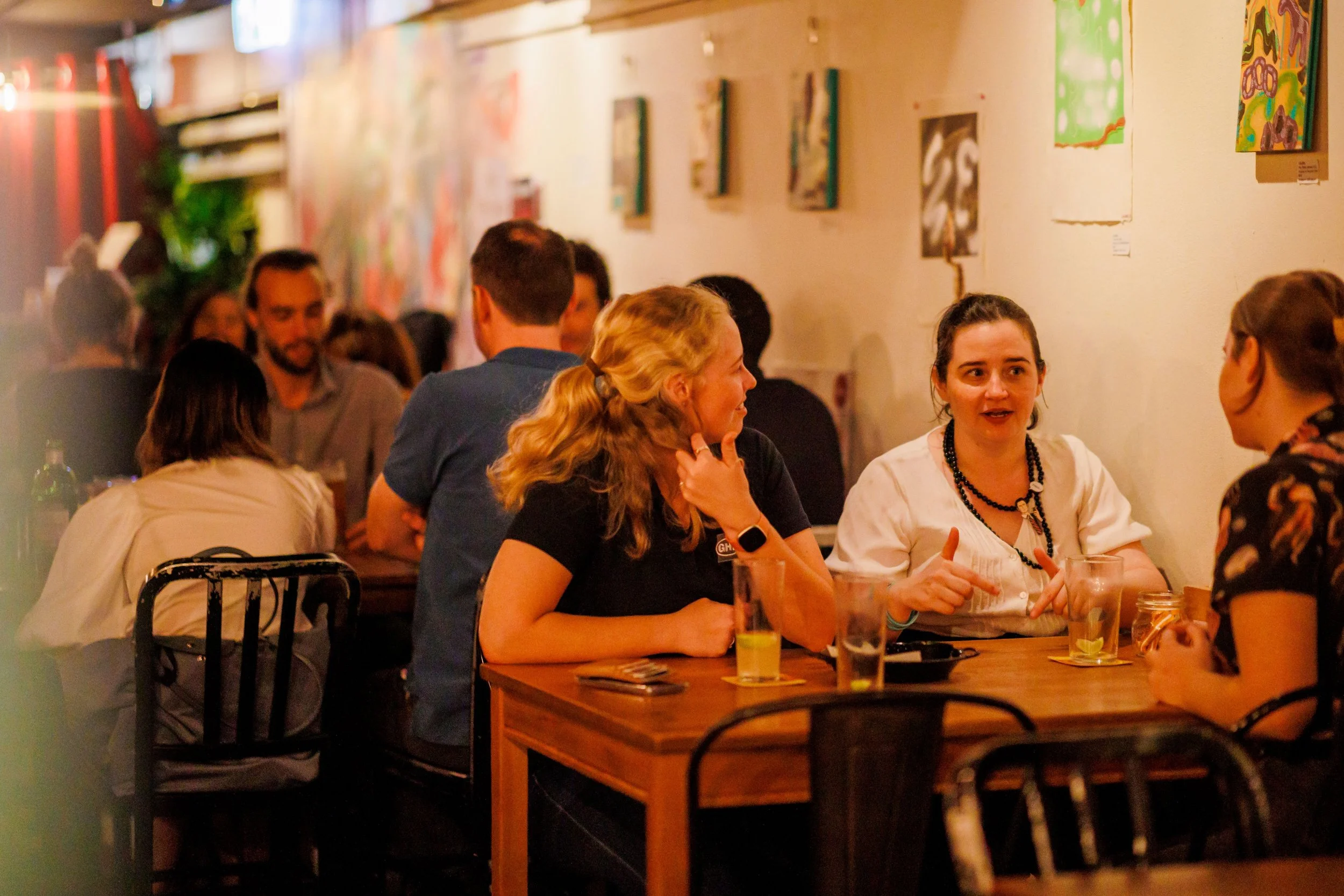 Friends sharing conversation over wine at Brew Cafe and Wine Bar, a relaxed wine bar in Brisbane CBD