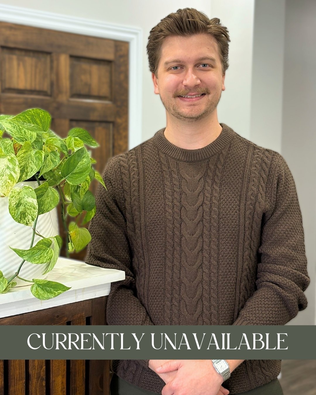 Ryan LeRoux, RP (Qualifying) - A smiling man with light brown hair, wearing a brown cable-knit sweater, and leaning on a wooden counter with a green leafy plant nearby and a caption that reads "Accepting New Clients."