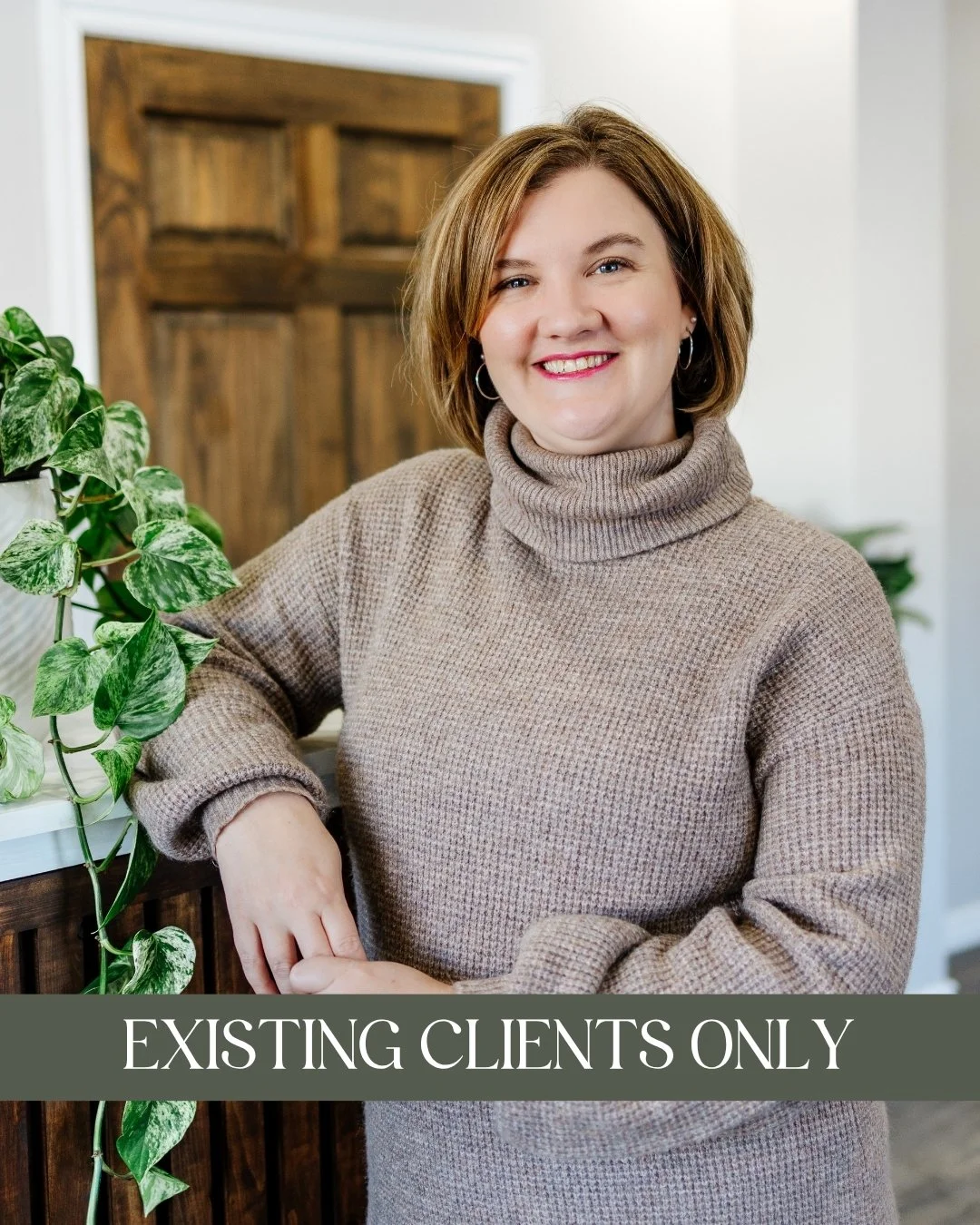 Myanna Adams Branch, MSW,RSW - A smiling woman with short brown hair, wearing a beige turtleneck sweater, and leaning on a wooden counter with a green leafy plant nearby and a caption that reads "Currently Unavailable."