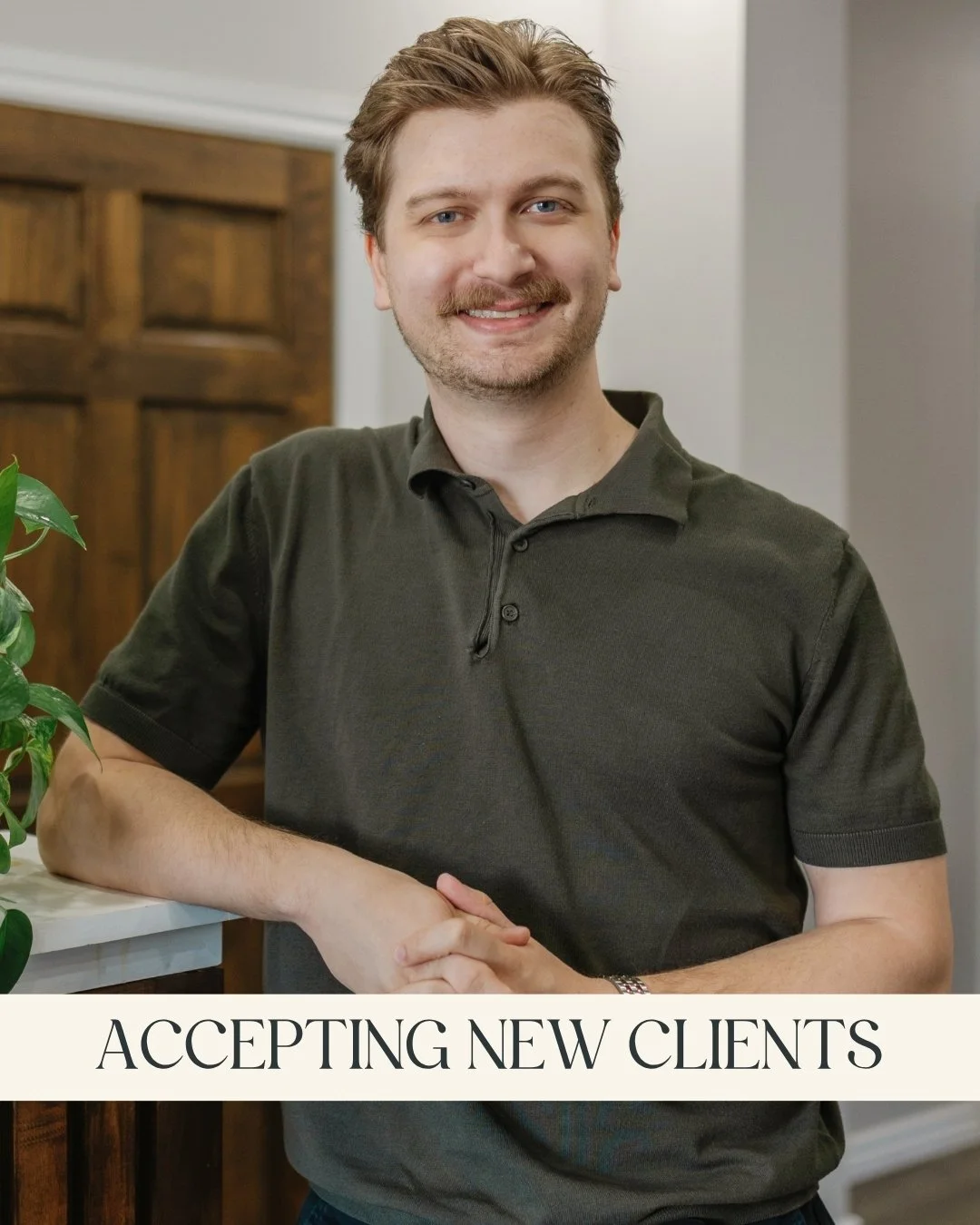 Ryan LeRoux, RP (Qualifying) - A smiling man with light brown hair, wearing a brown cable-knit sweater, and leaning on a wooden counter with a green leafy plant nearby and a caption that reads "Accepting New Clients."