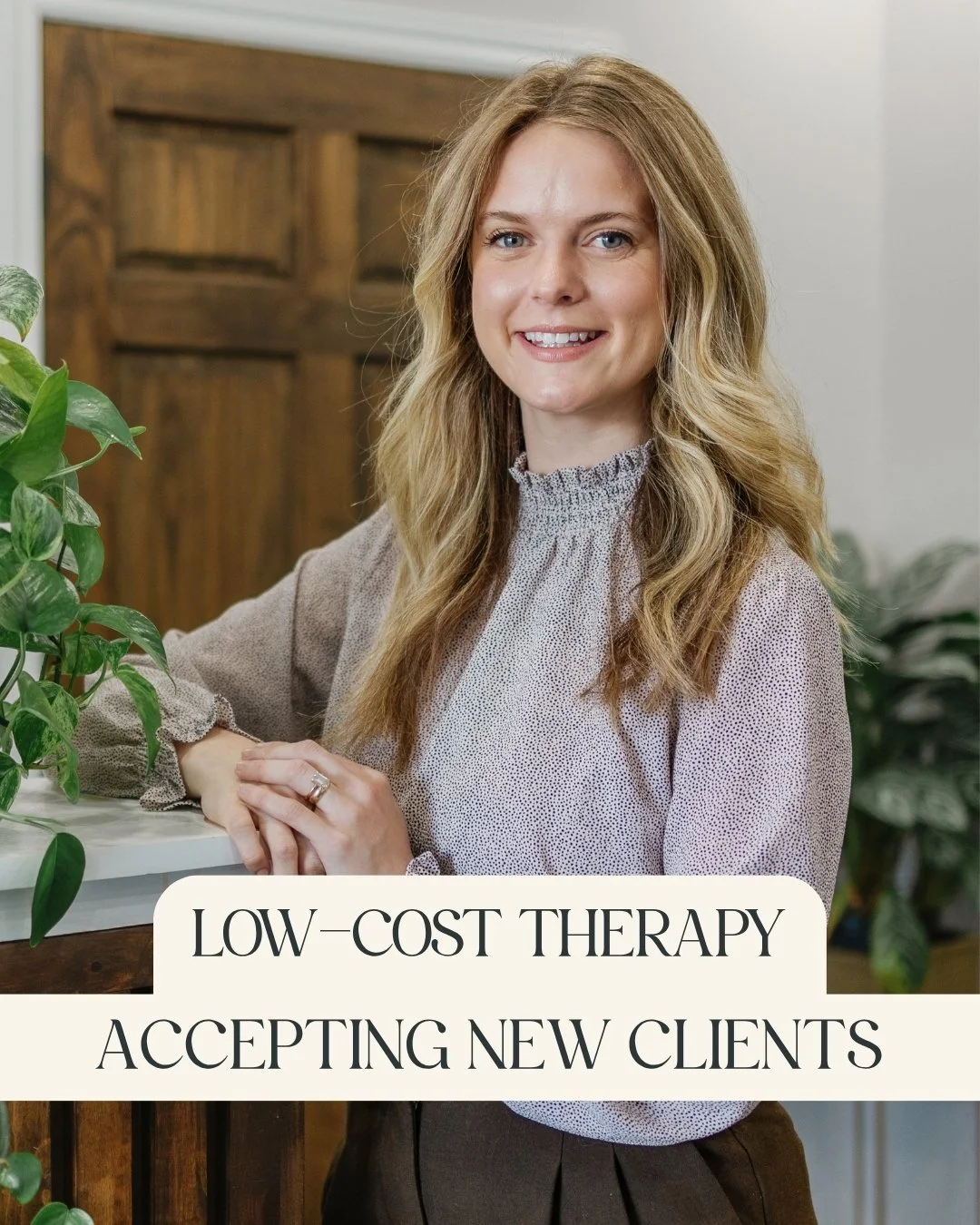 Claire Packer, RP (Qualifying) Intern - A smiling woman with long blonde hair wearing a gray blazer and black shirt, and leaning on a wooden counter with a green leafy plant nearby and a caption that reads "Low-Cost Therapy, Accepting New Clients."