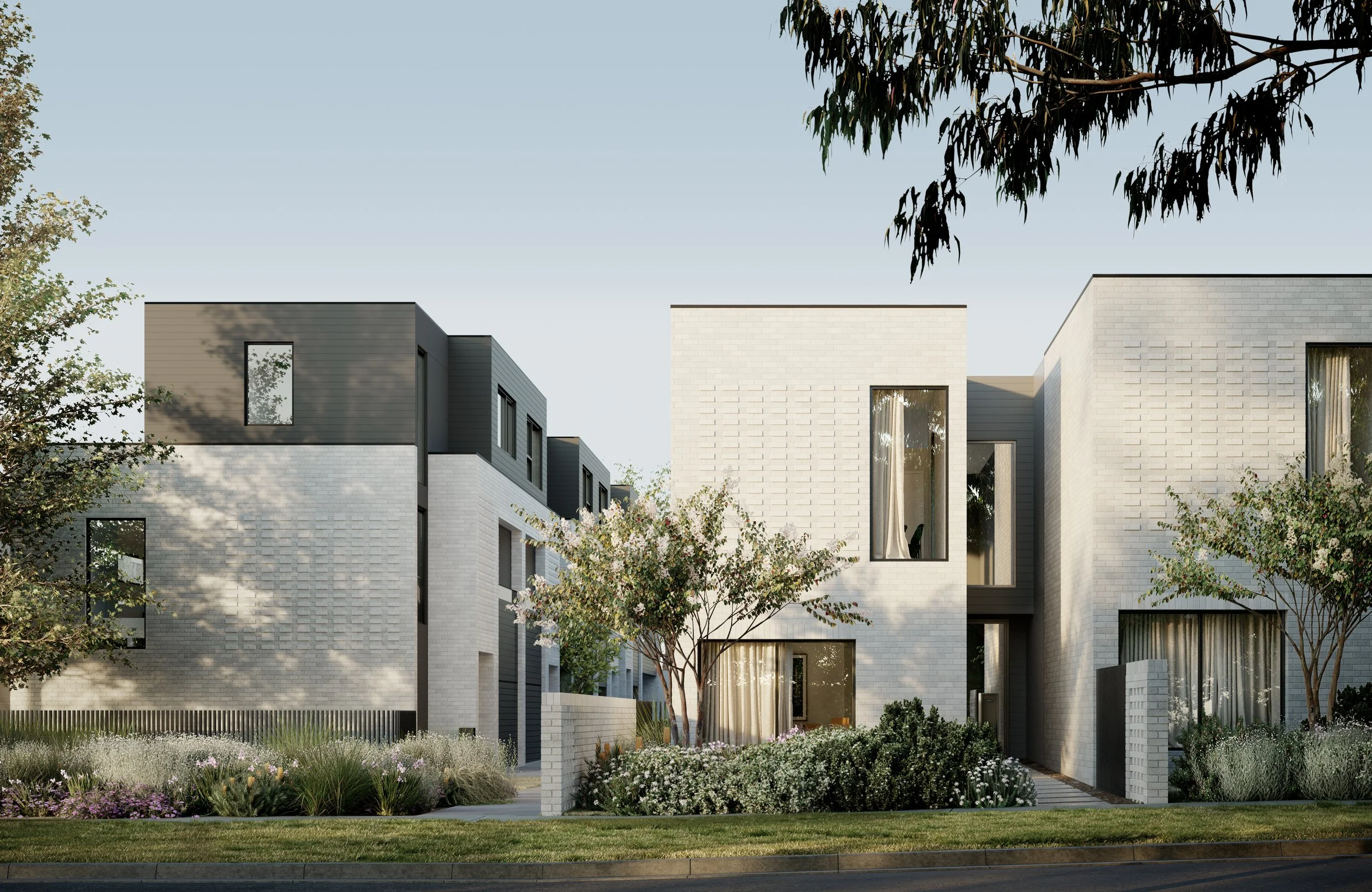 Modern residential building with minimalist design, featuring white brick facade, large windows, and landscaped garden.