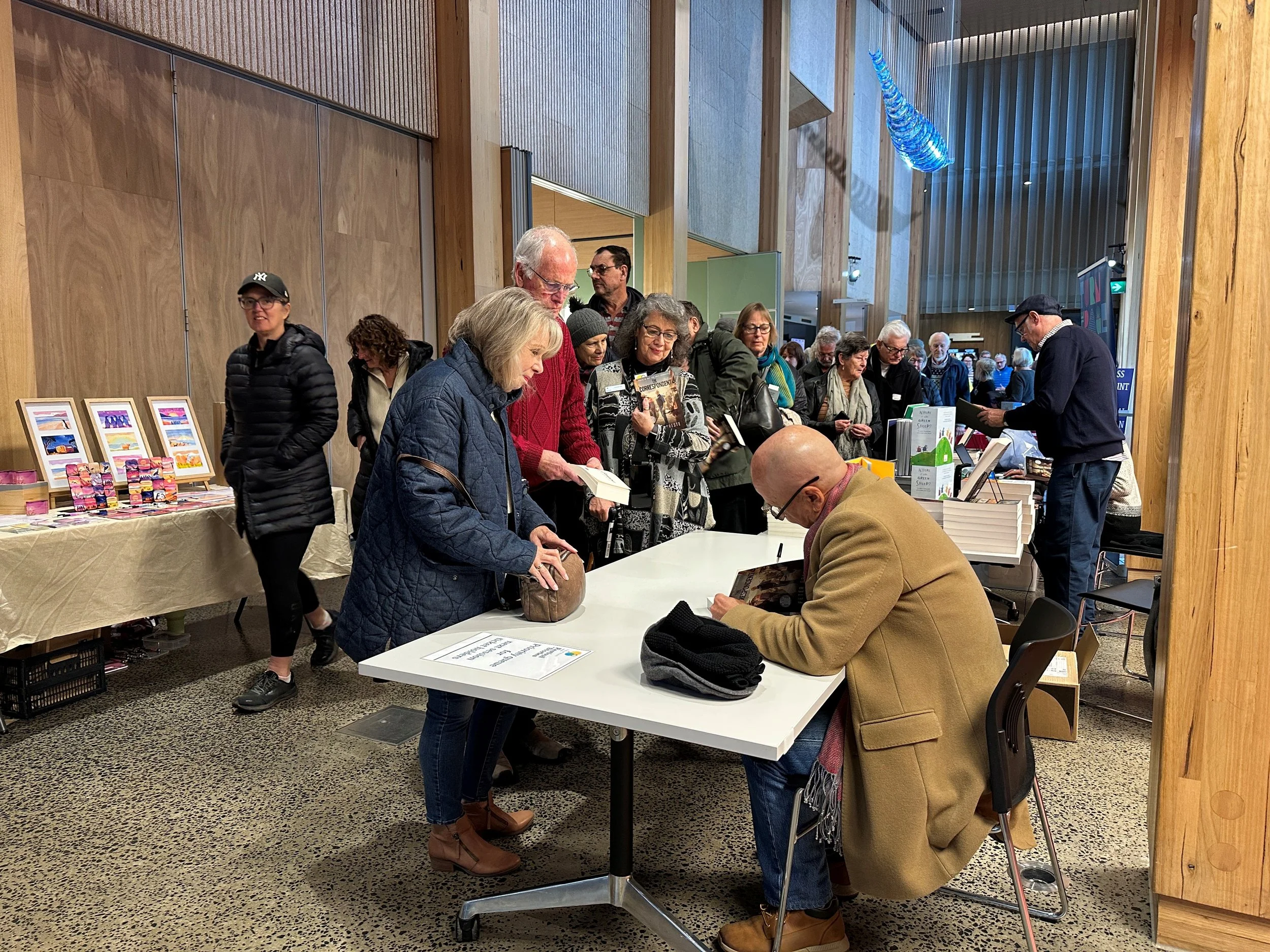 Peter Greste signing books.jpg