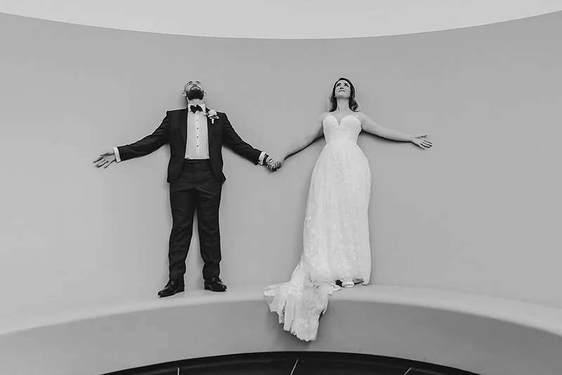 A canberra couple having fun on their wedding day. Here they are playing in teh James Turell Skyspace at the National Gallery of Australia.