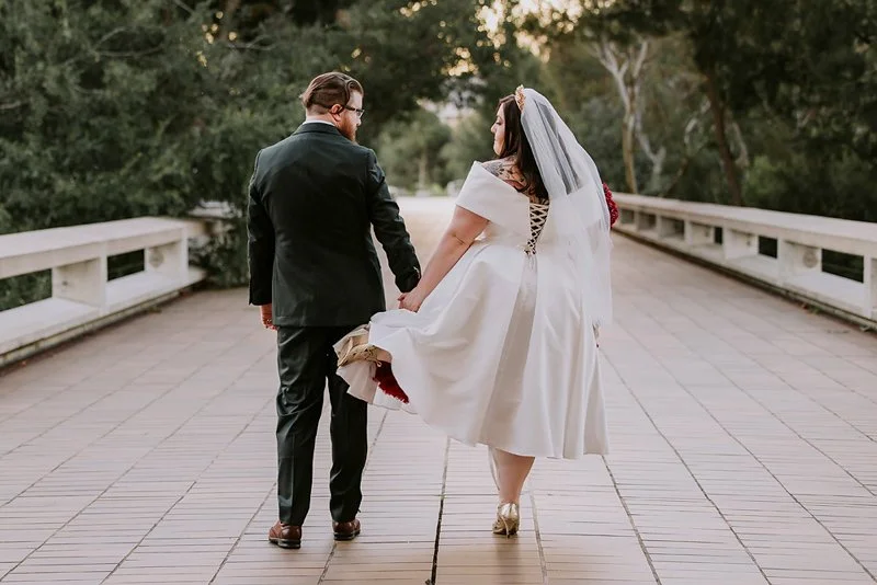 A young wedding couple having fun on their wedding portrait session.  It was all giggles and laughs at this Canberra wedding at the National Gallery of Australia with Tracy Lee Photography