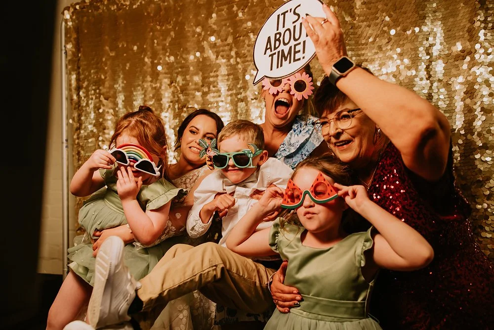 Your guests having photo fun in the photo booth at your wedding reception