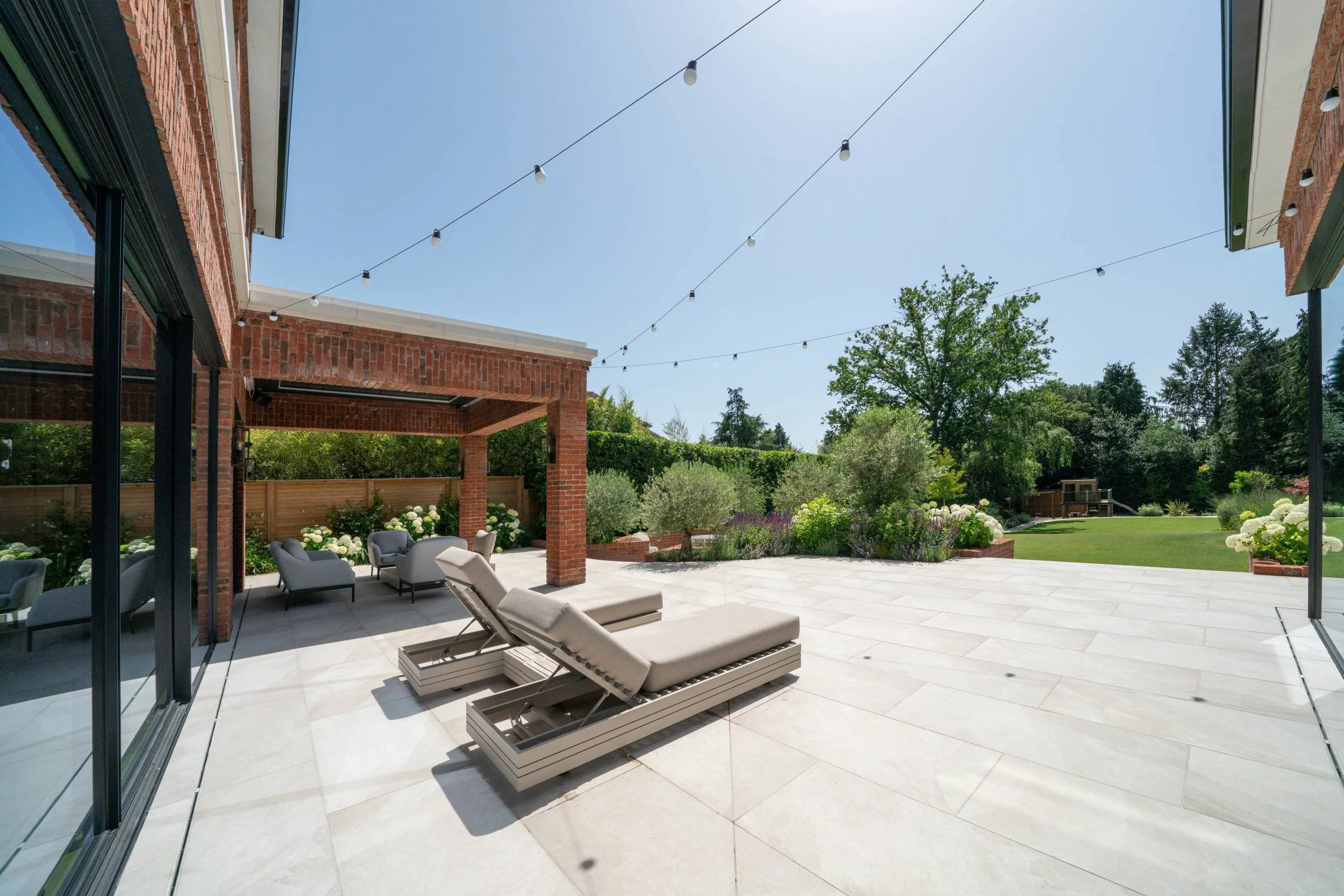 Terrace, pergola and lawn of a newly built Cobham garden after planting by Paul Studholme