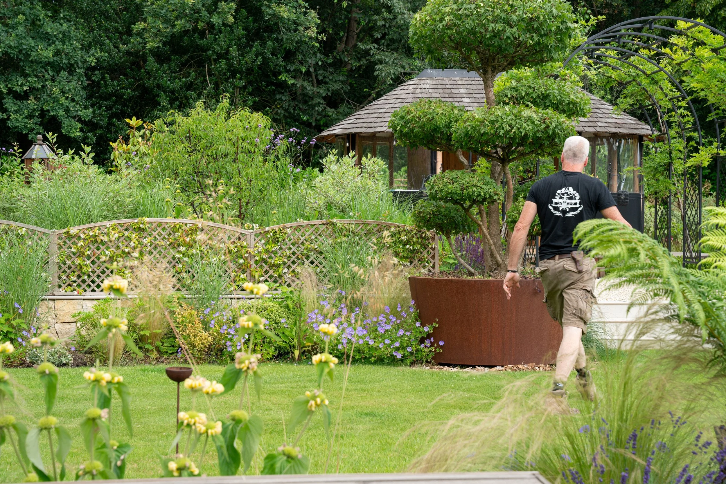 Paul Studholme walking through a garden in Cobham, Surrey.