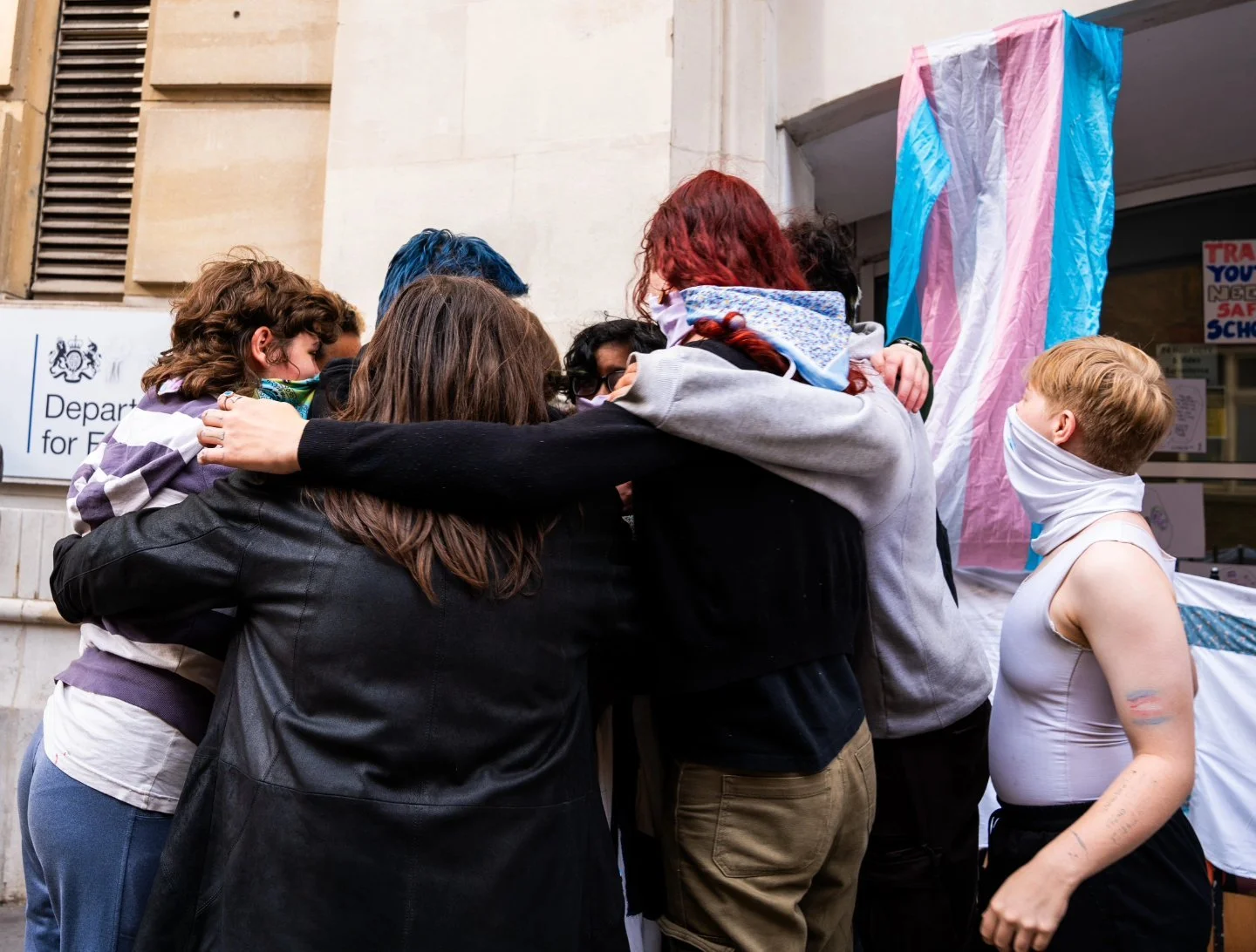   Activists embrace one another after recovering their banner (Credit: Alyx Bedwell, 