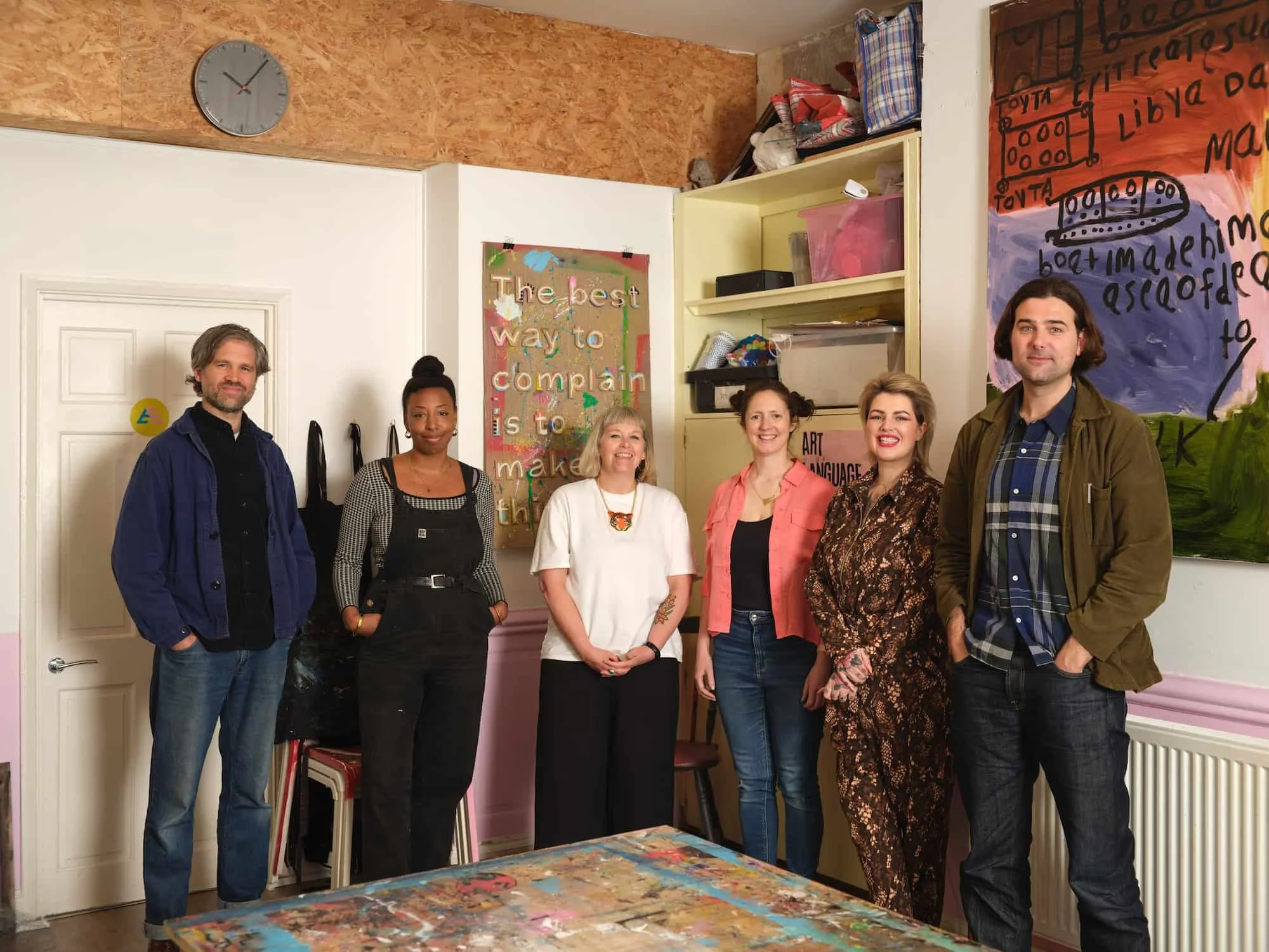 Our team stood together smiling in the art studio
