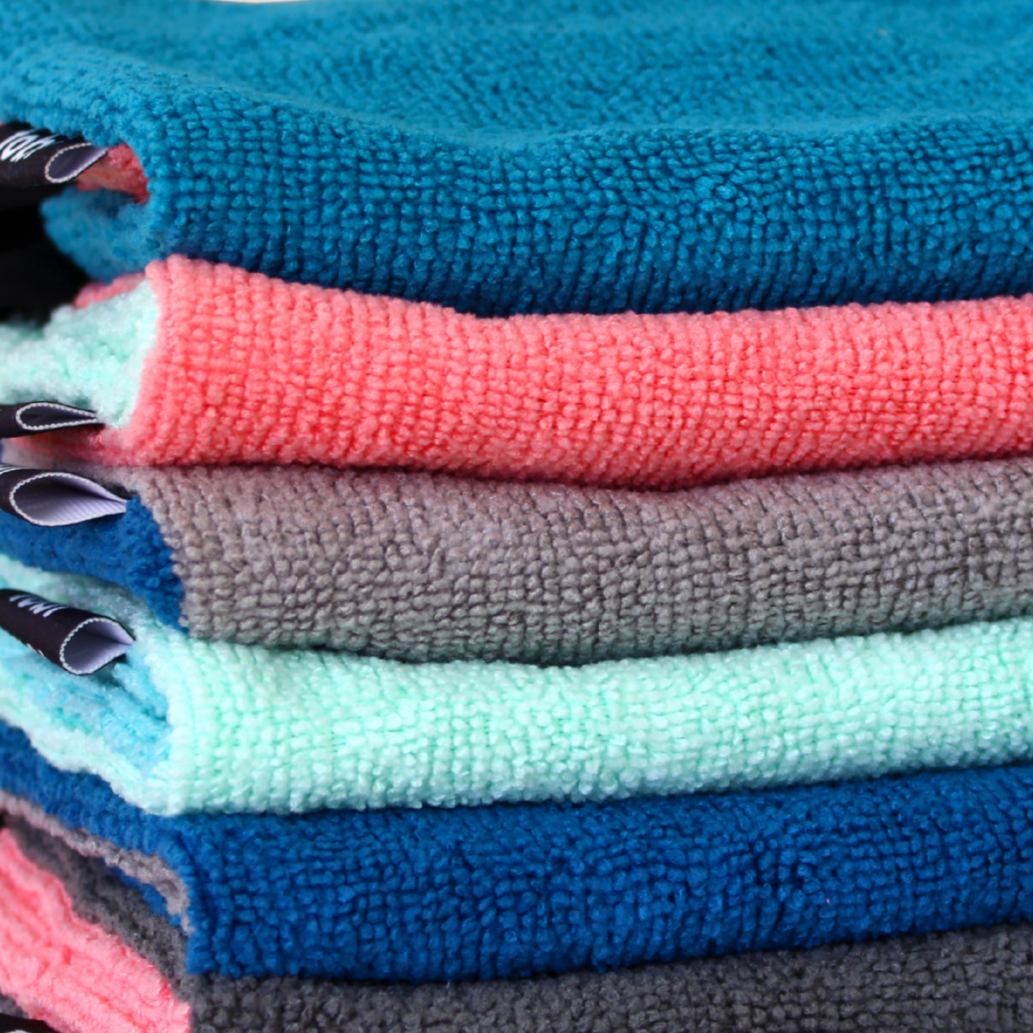 Stack of folded tobi's in various colors, including blue, pink, gray, green, and darker blue.