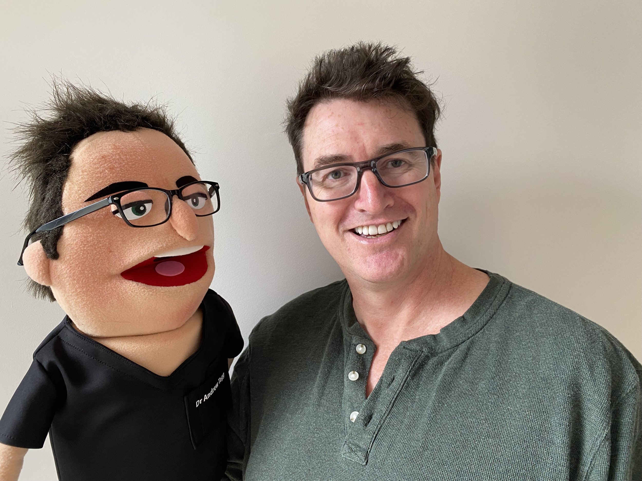 A puppet version of Andy in black scrubs
