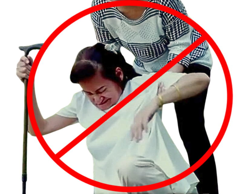 Caregiver manually assisting elderly person up from floor with cane highlighting difficulty and injury risk without lift assist device