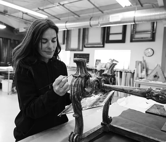 Susie Anders restoring an antique stool