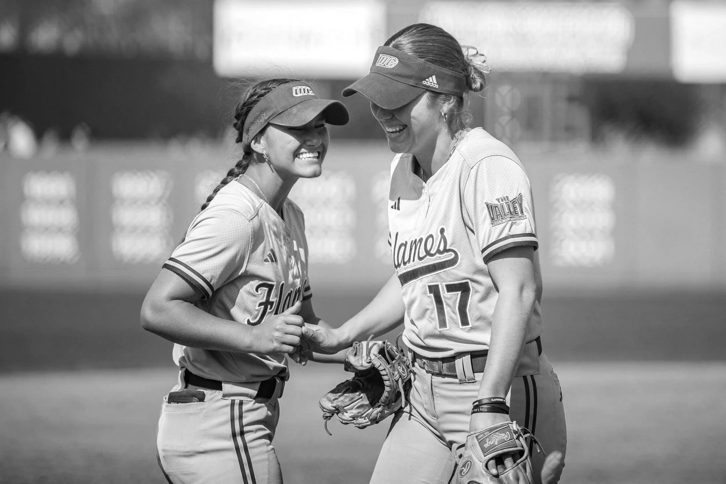 Two softball players handshake after a play