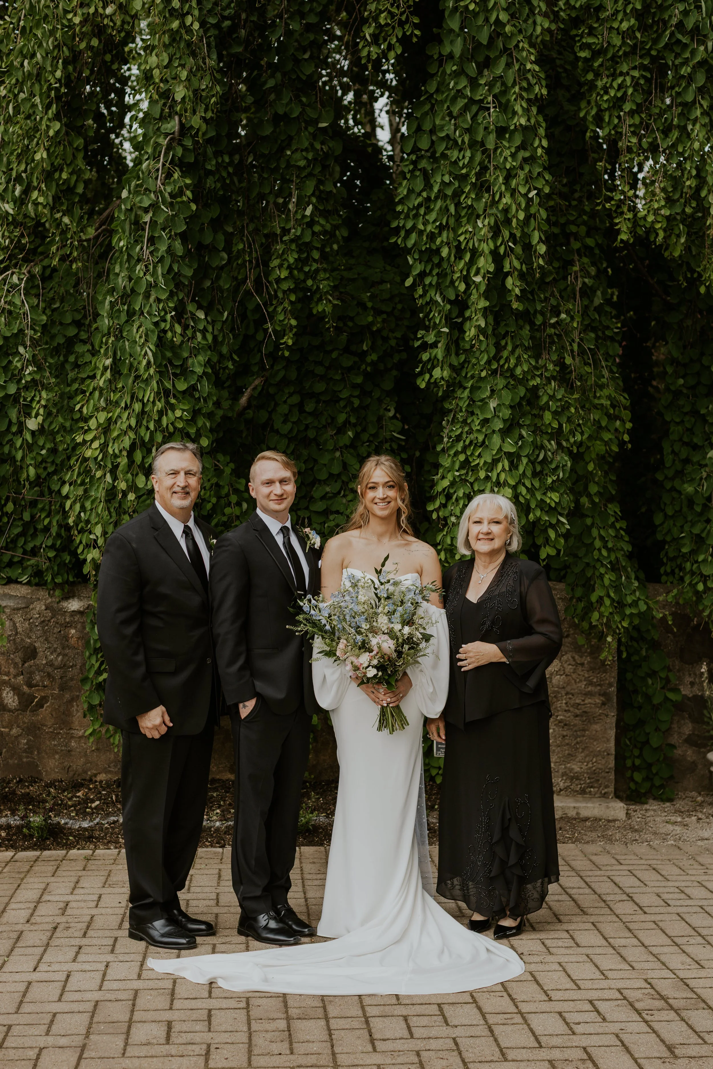 family wedding portrait in front of willow tree in boerner botanical gardens