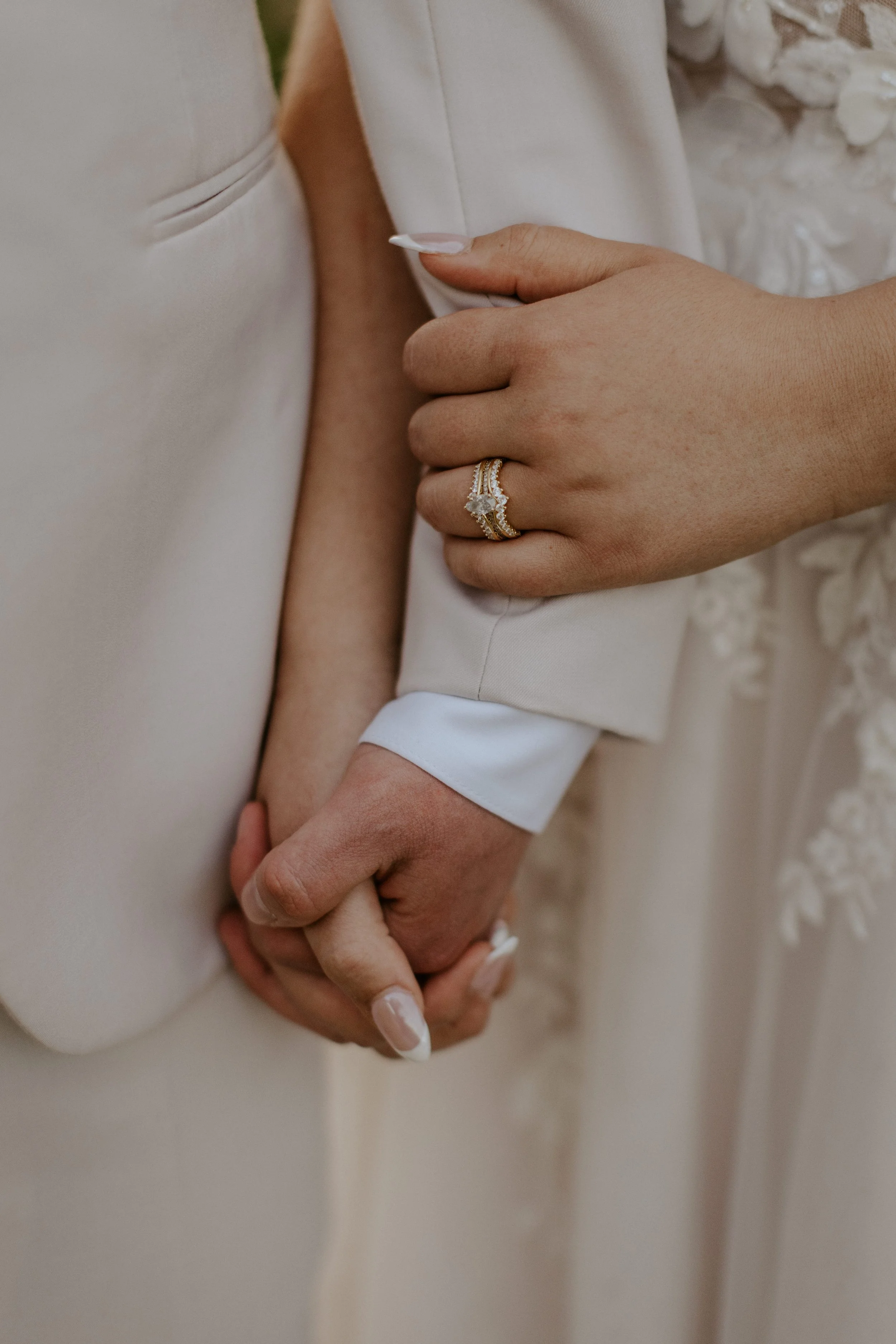 close up of bridal couple holding hands