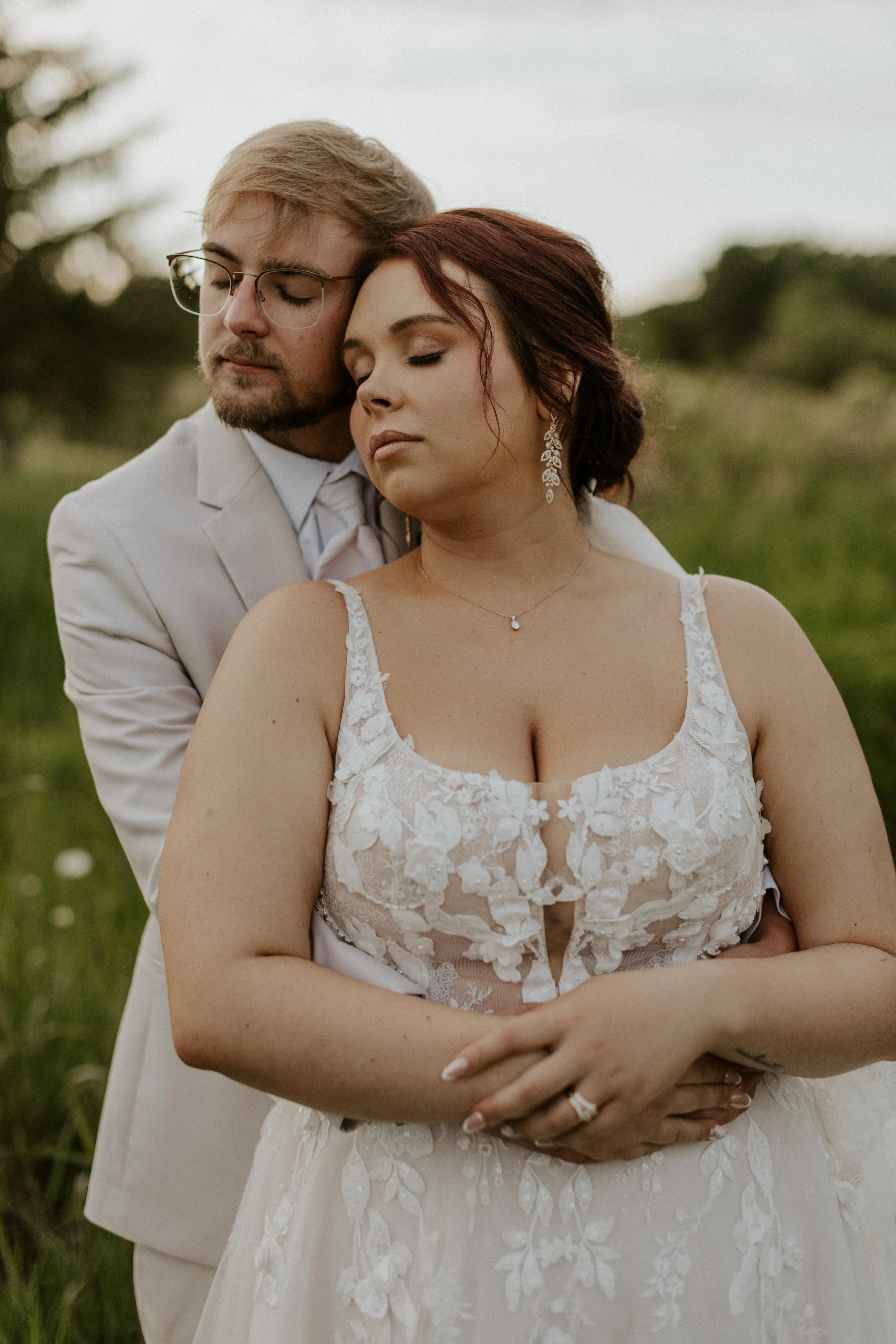 groom embracing bride from behind