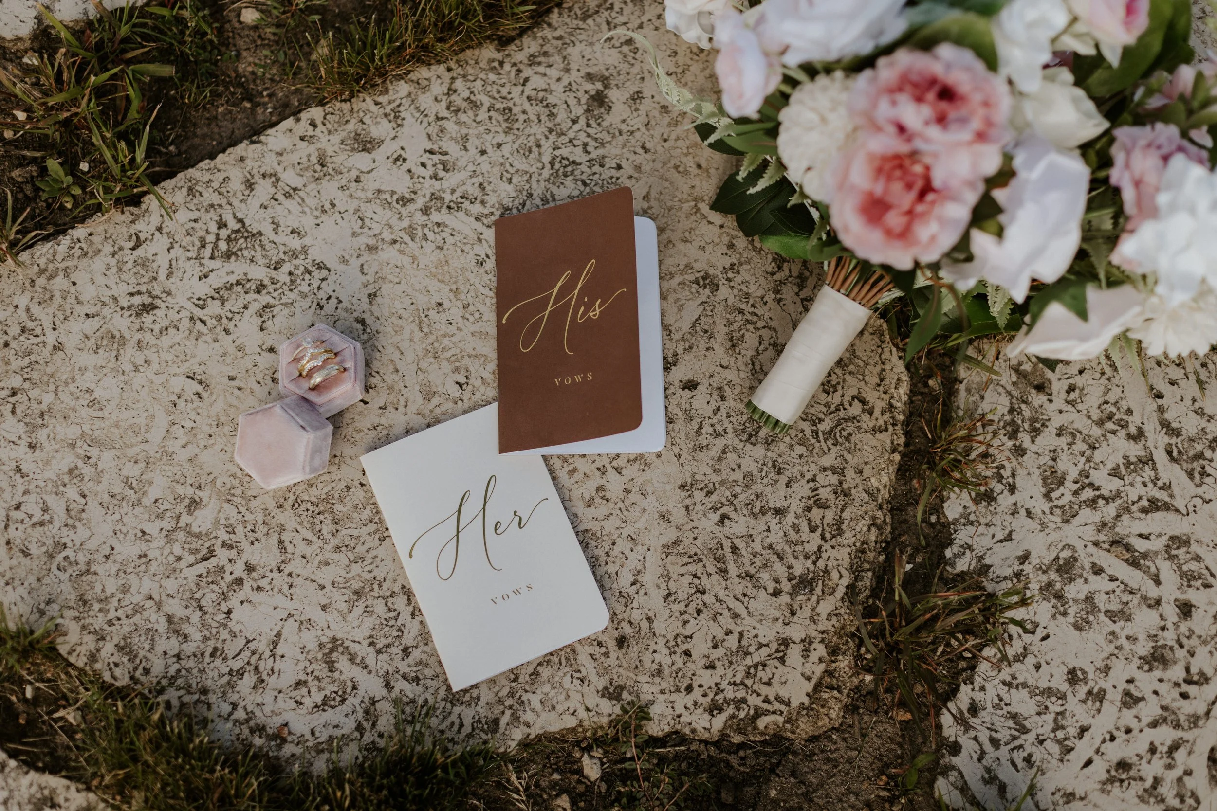 bouquet and vow books laying on ground