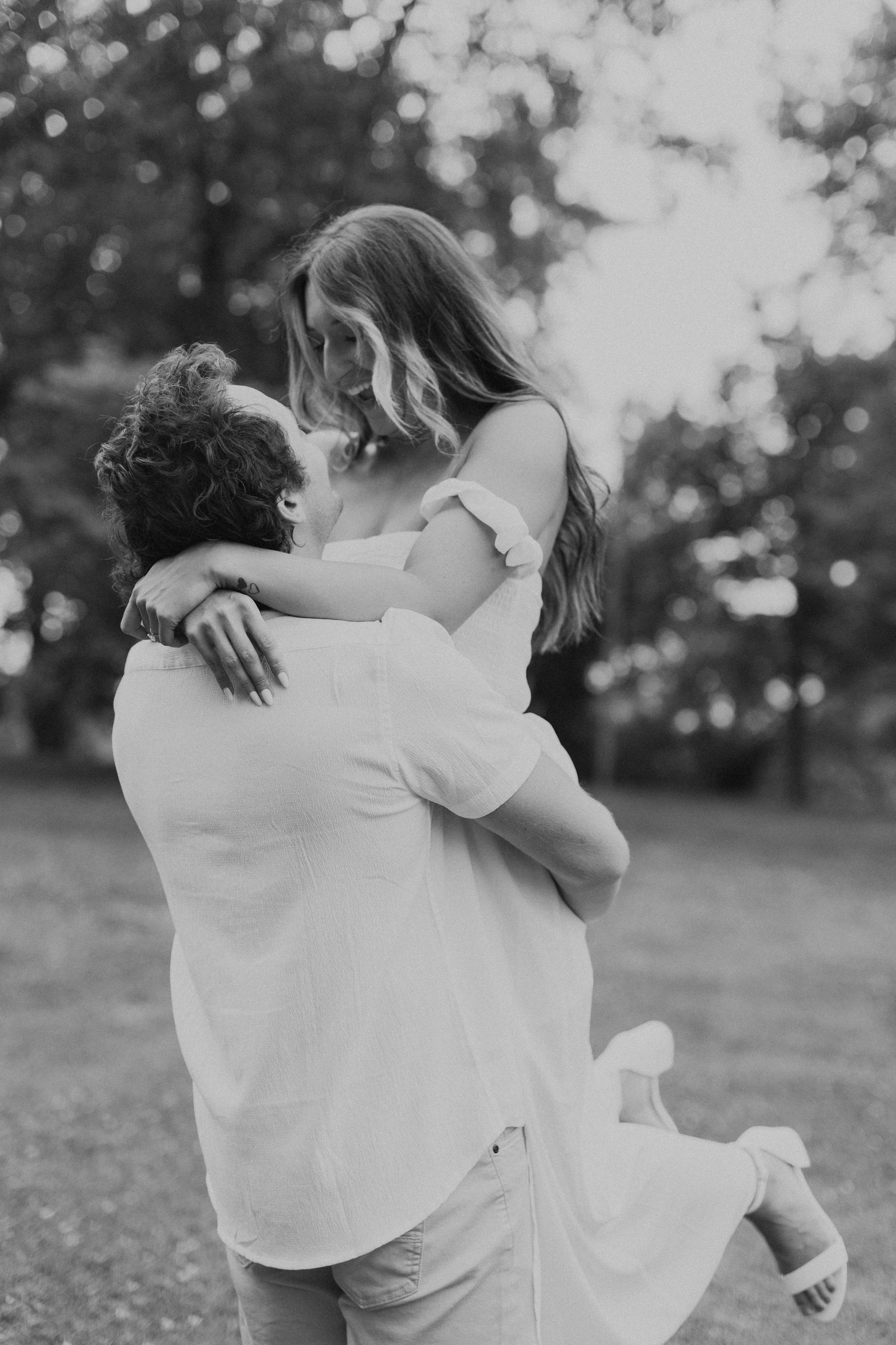 Man lifting up woman and spinning her around