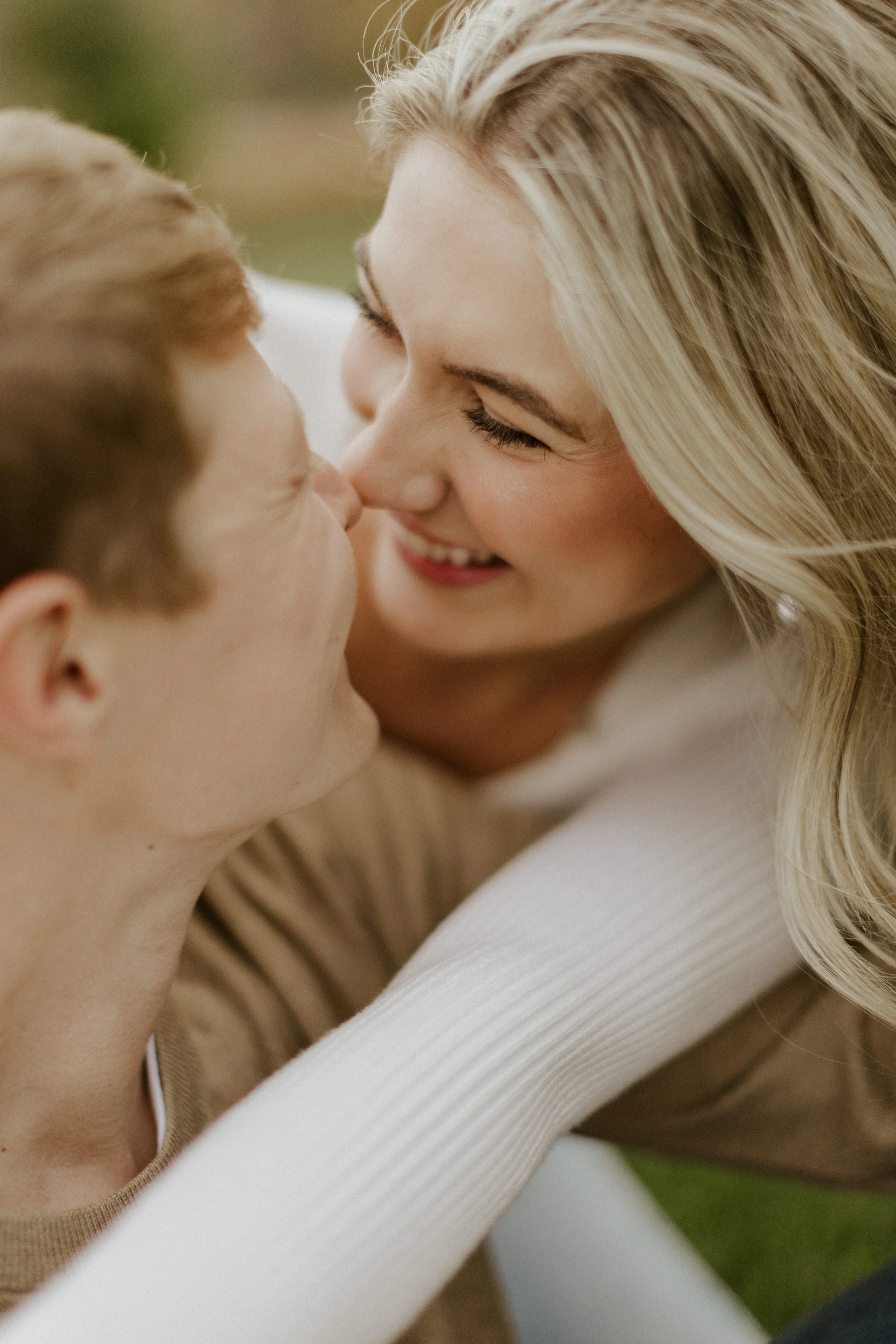 close up of young couple touching noses and laughing