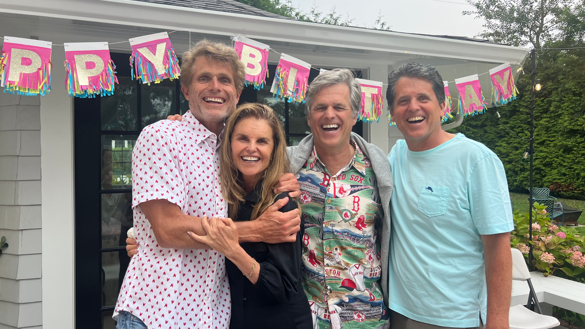 Tim hugs family at a birthday party