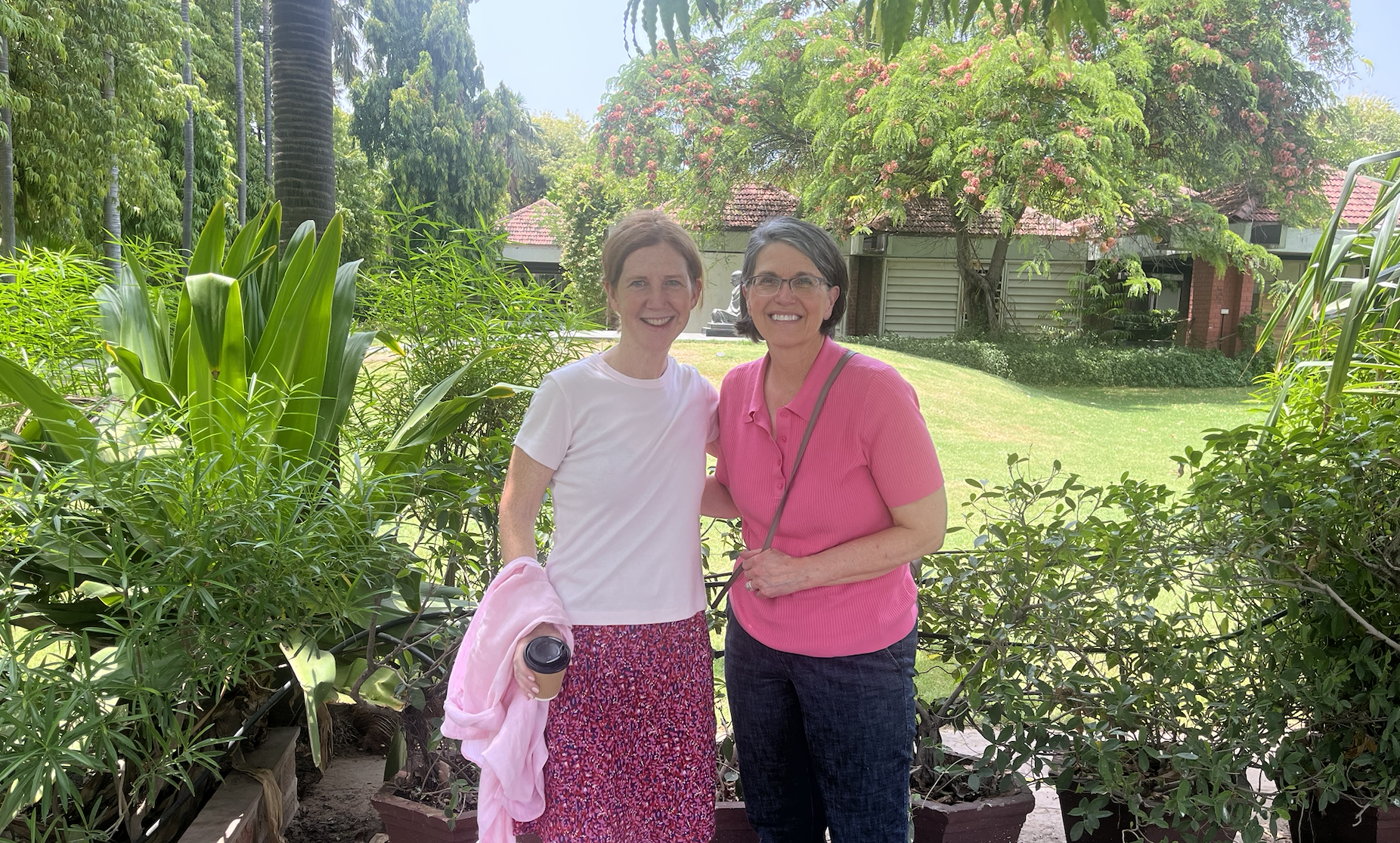 Tami and Alicia in a lush garden