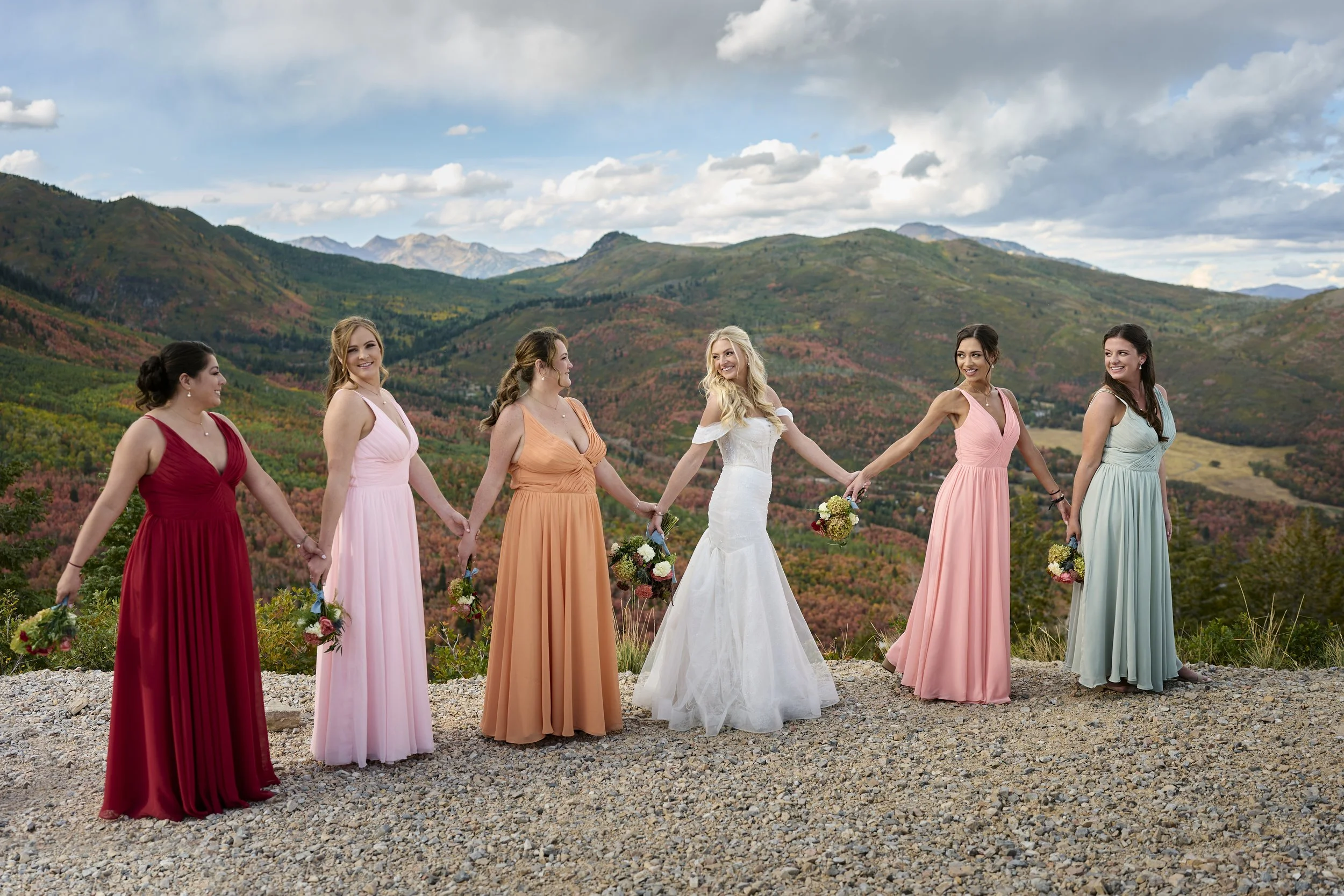 Mulit colored bridesmaid dresses worn by bridal party at Utah mountain wedding planned by Heirloom Weddings & Events in Utah.