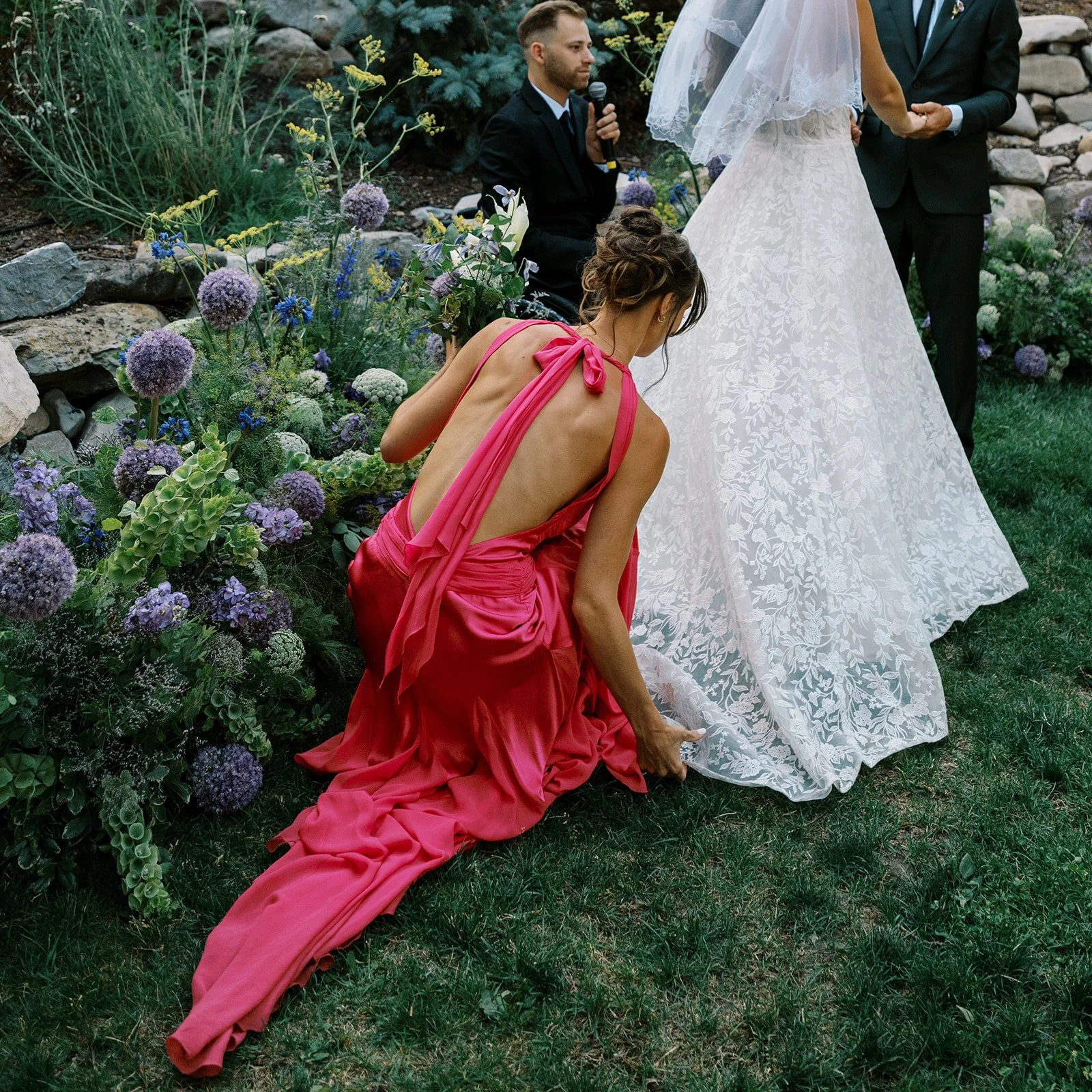 Redford Conference Center wedding ceremony at Sundance resort. The maid of honor is adjusting the lace bridal gown.