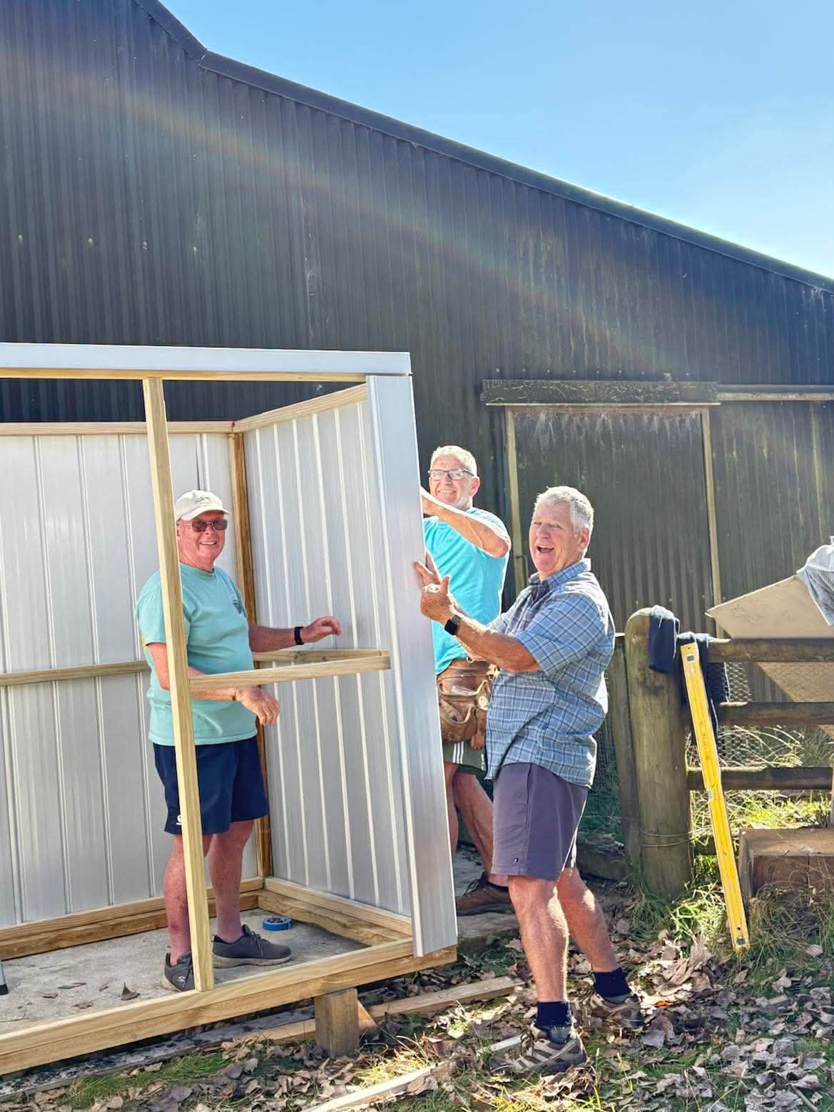 Predator Free Tamahere volunteers assembling a new storage shed for traps and conservation supplies.