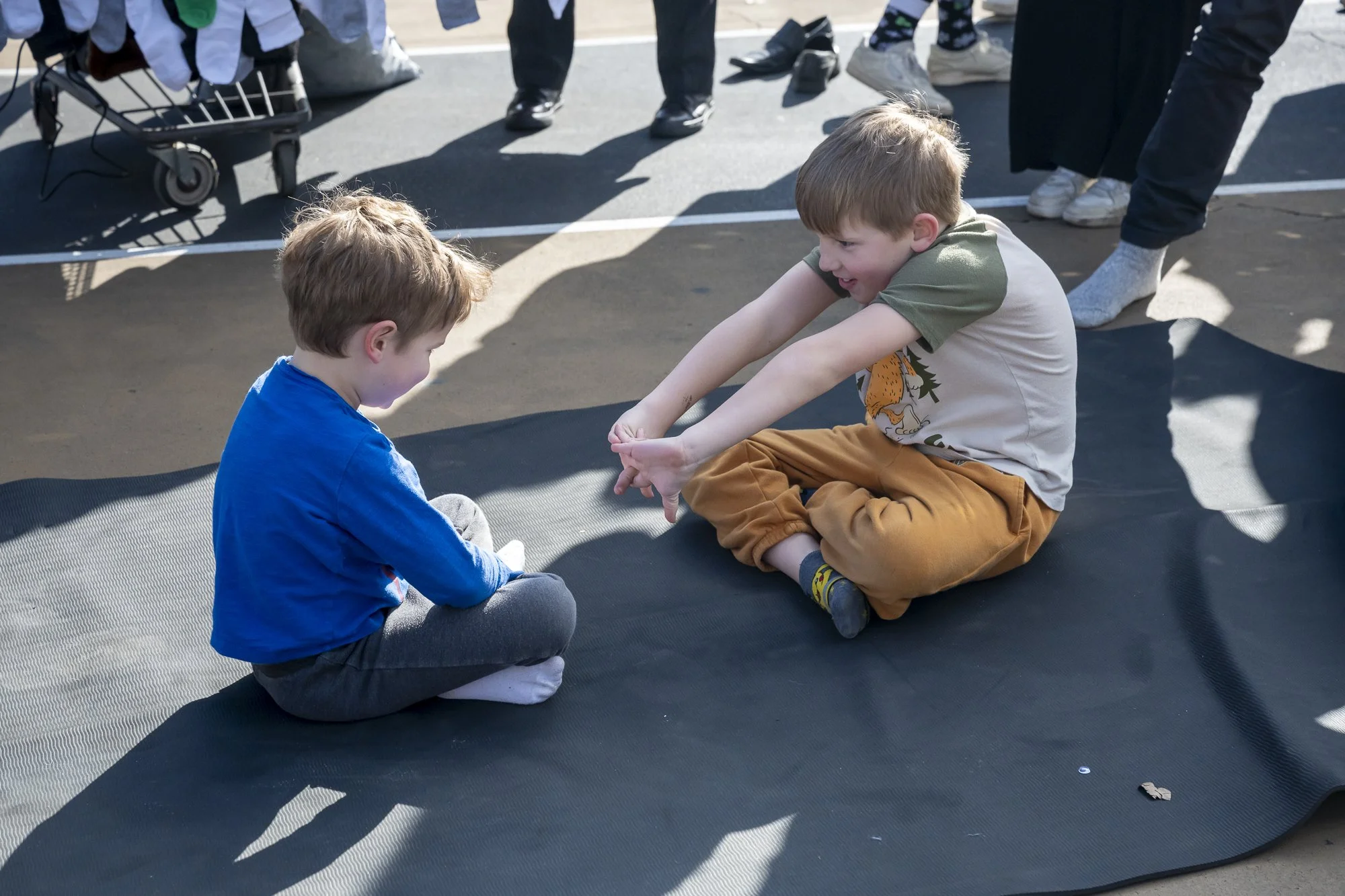Two kids prepare to wrestle each other at New York Sock Exchange in Cooper Park