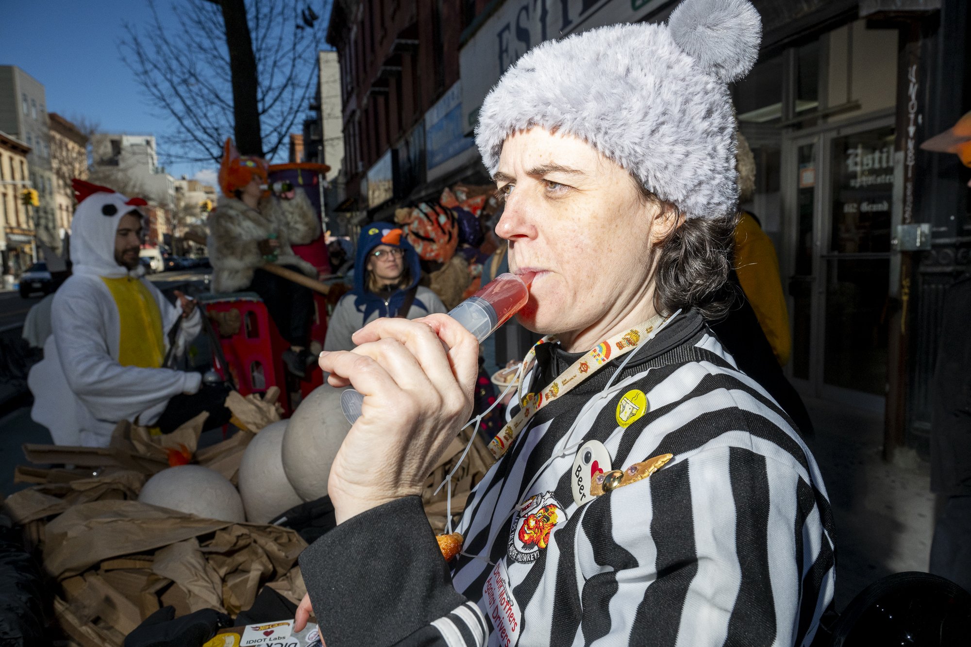 Anney samples Coney Island Cyclone's drink item: a syringe filled with a homemade Nutcracker