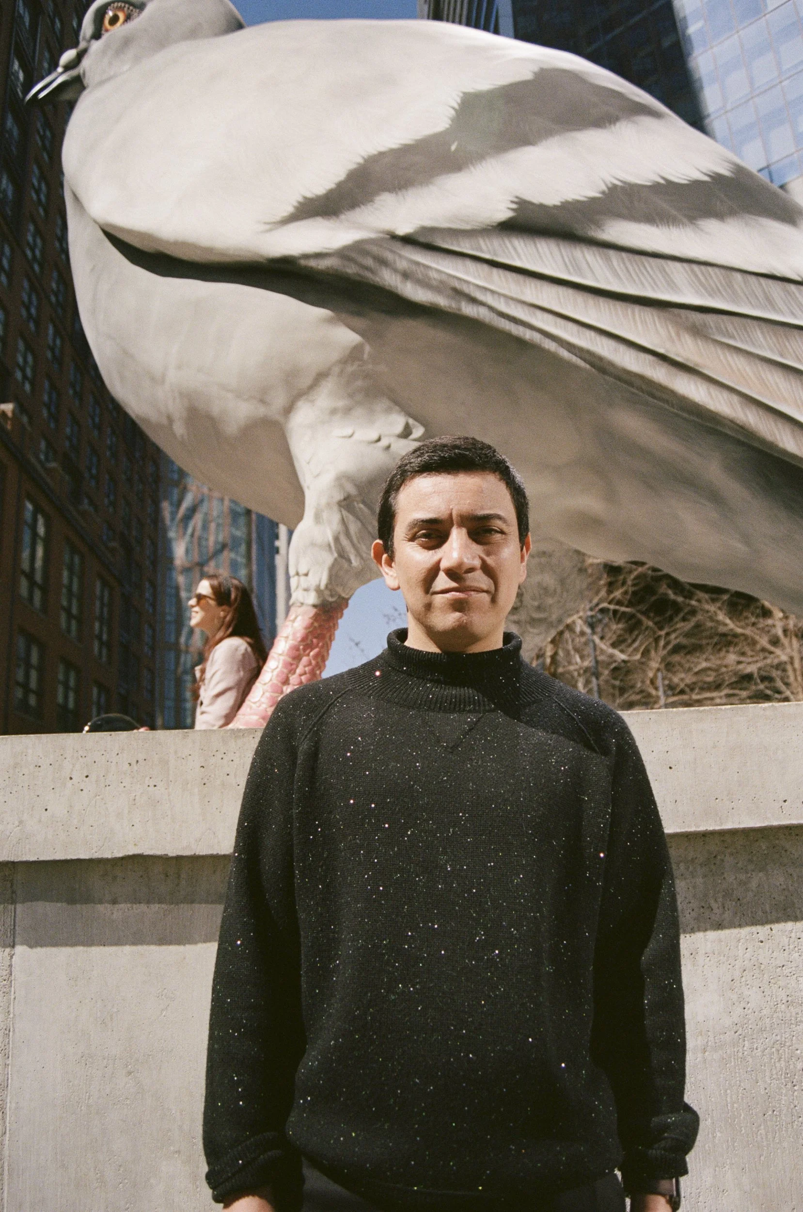 Artist Iván Argote, who created "Dinosaur" in the background