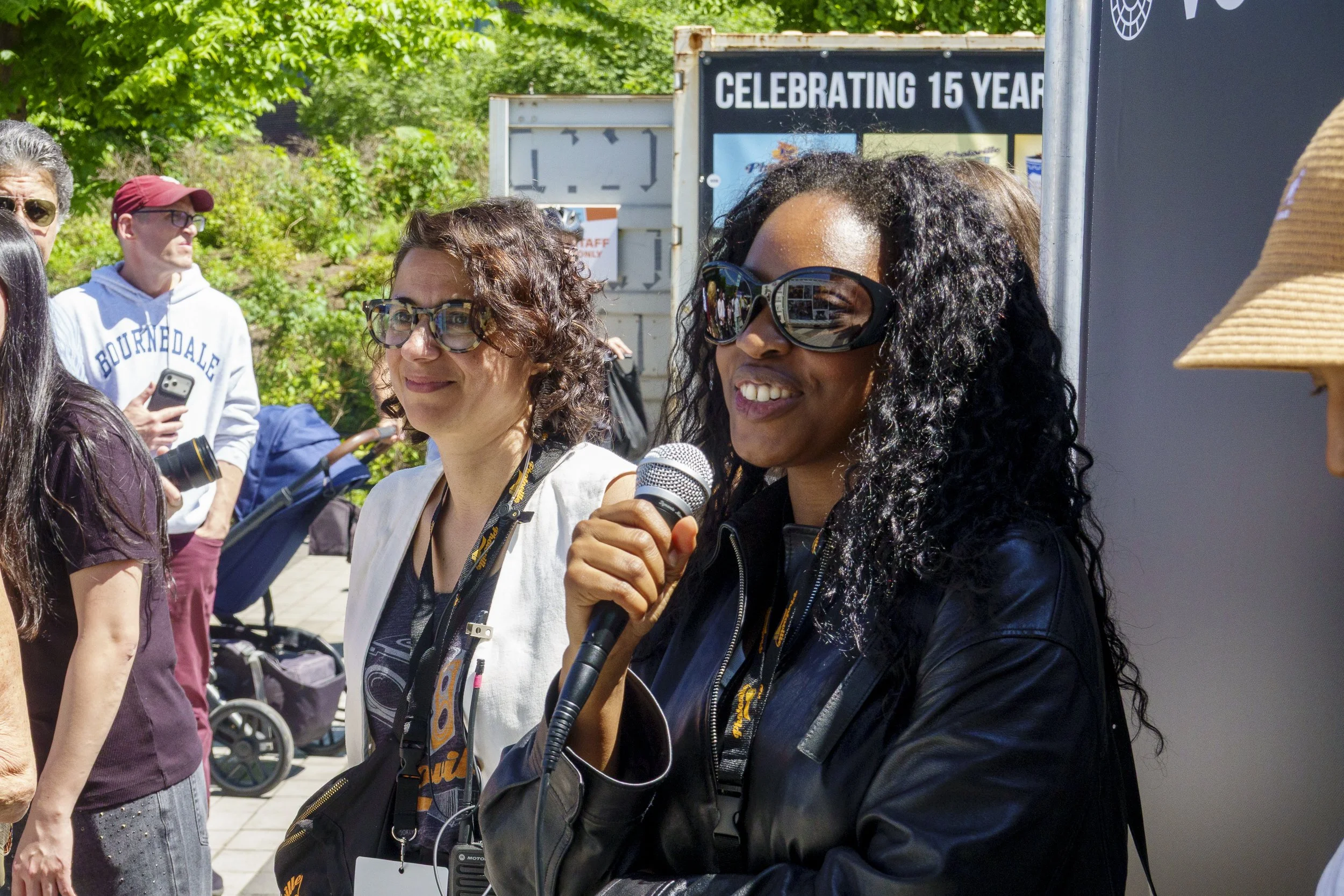 Bre Johnson speaks during Photoville tour. Laura Roumanos, co-founder of Photoville, is to the left