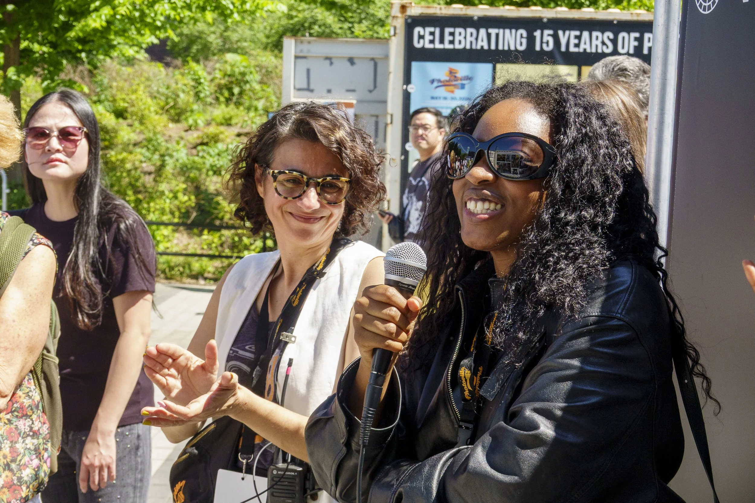 Bre Johnson speaks during Photoville tour. Laura Roumanos, co-founder of Photoville, is to the left