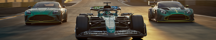 Race cars on a track at sunset, with a Formula racing car in the center and two luxury sports cars on either side.
