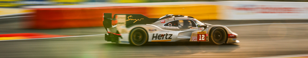 Race car speeding on a track with blurred background