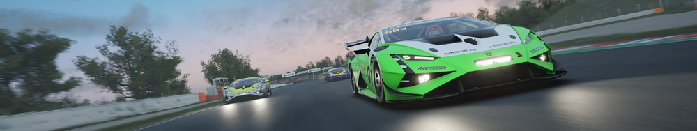 Green race car leading on a racing track with two other cars following behind, trees and trackside barriers in the background.