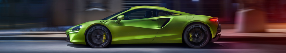 A vibrant green sports car moving at high speed on a city street with blurred background.