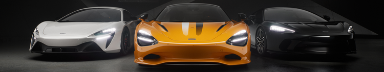 Three luxury sports cars parked side by side in a dark setting, featuring a white, orange, and black car from front view.