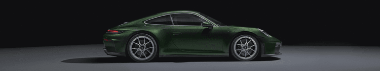 Side view of a shiny green sports coupe car on a plain gray surface with a black background.
