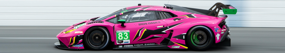 Pink race car with black, yellow, and green accents on a racetrack with a white garage door in the background.