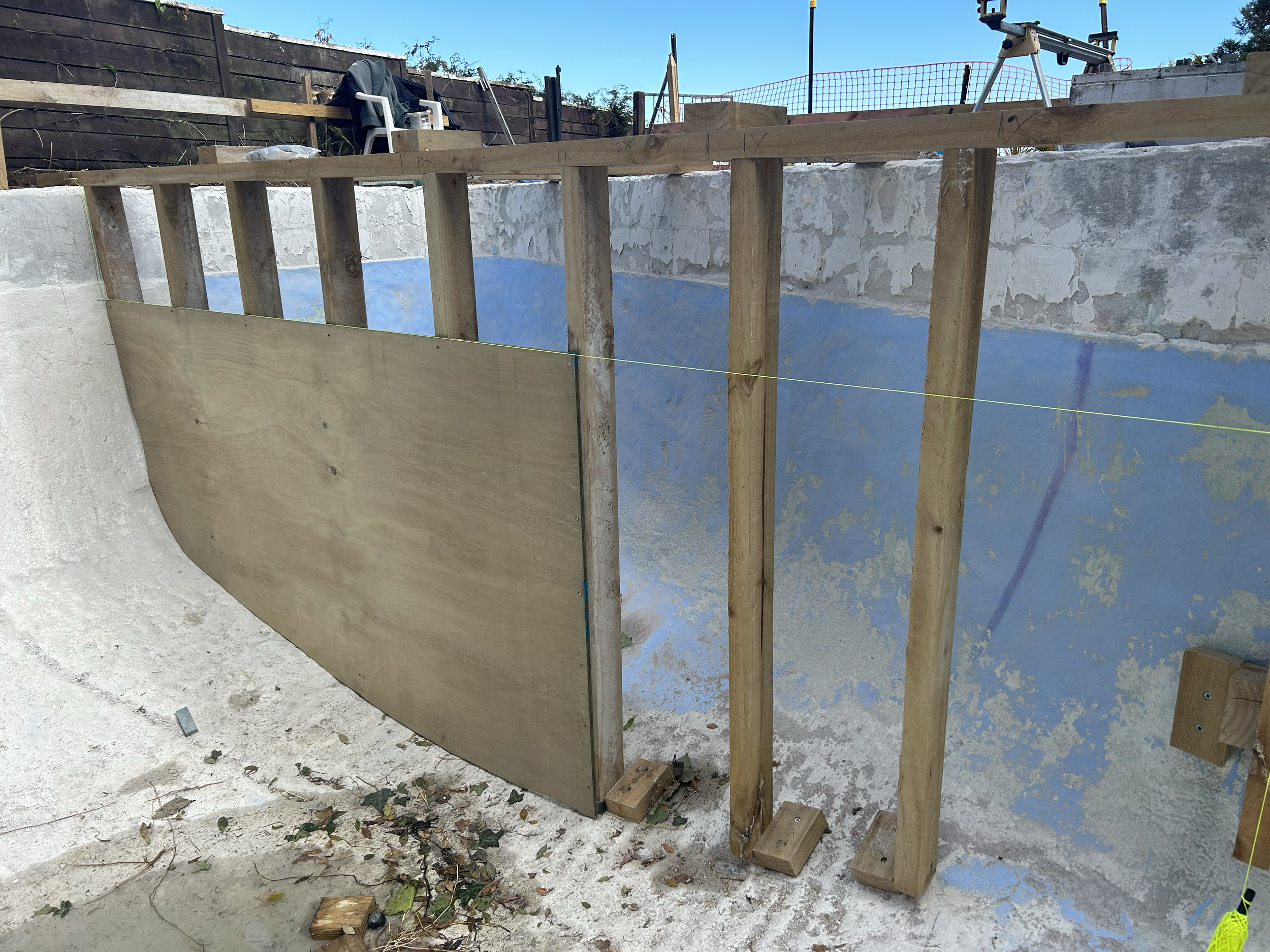 Under construction swimming pool with wooden framing and blue painted interior walls. Existing pool refurbishment Built by ESC outdoor living swimming pool builders. Auckland.
