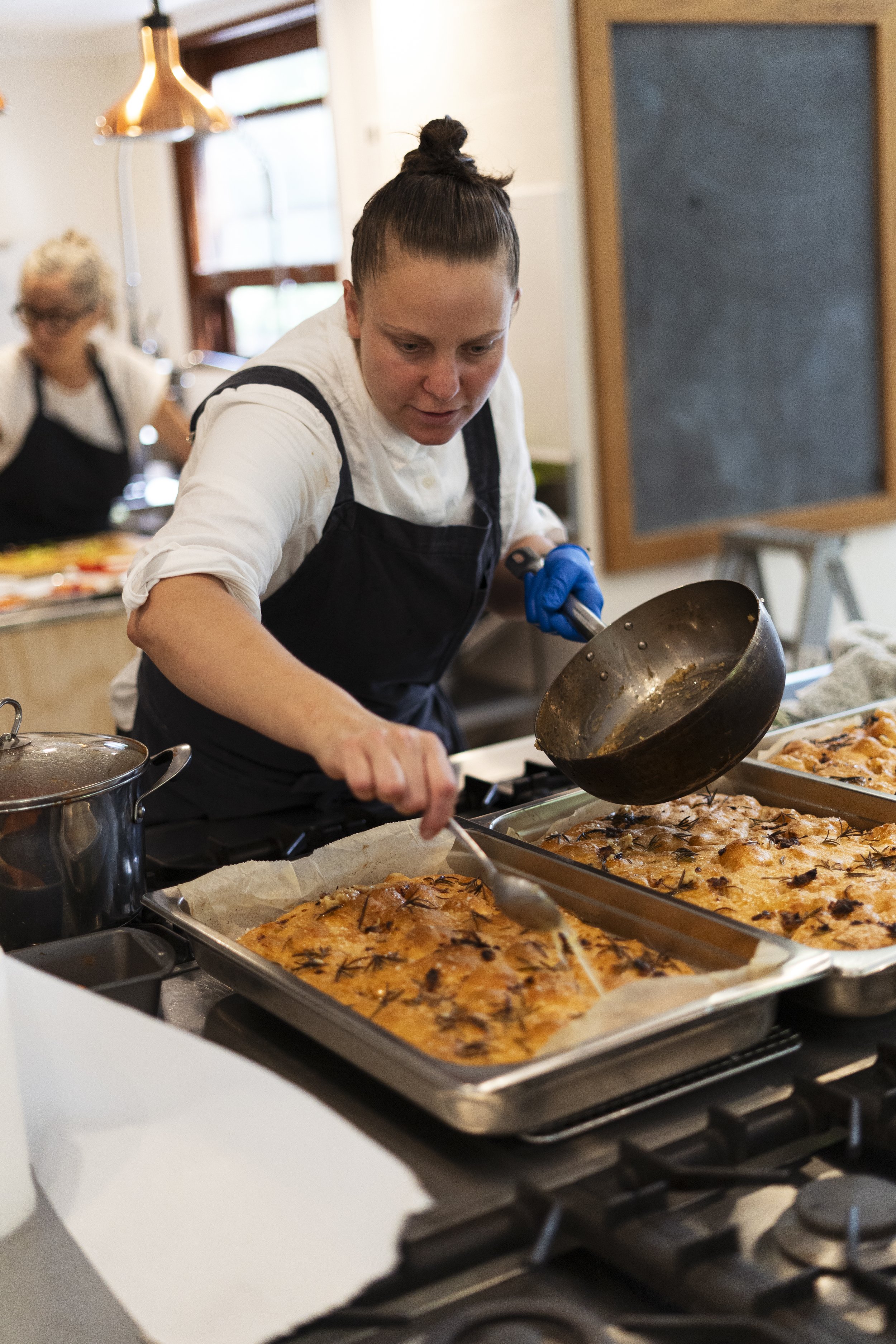 Sarah cooking with Theanna in background.jpg